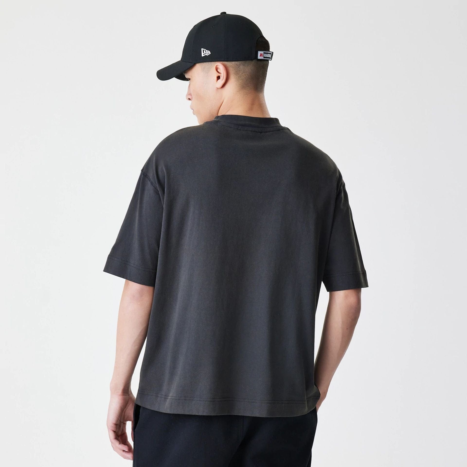 The Male model is wearing Las Vegas Raiders NFL Washed Boxy Dark Grey Oversized T-Shirt 2