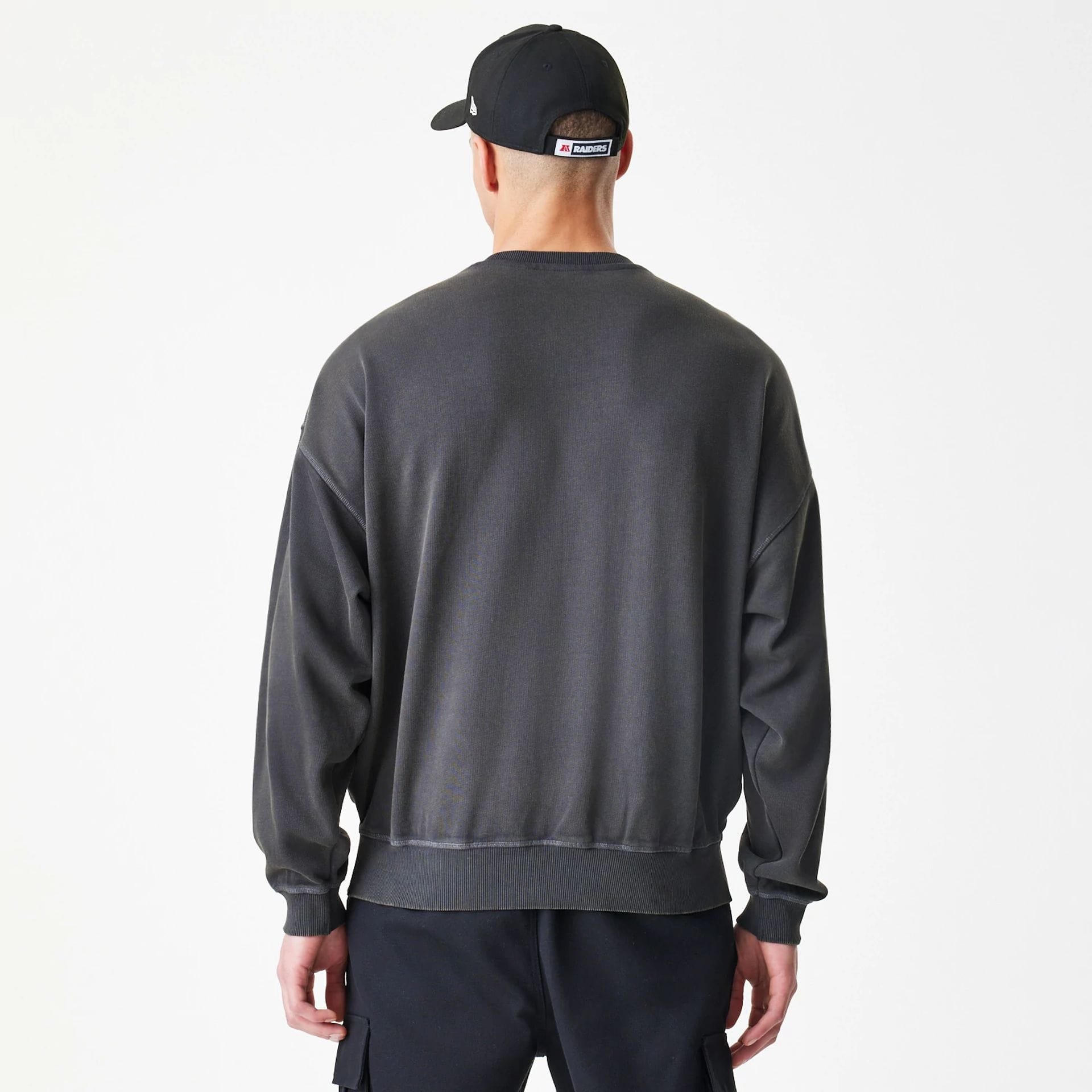 The Male model is wearing Las Vegas Raiders NFL Washed Boxy Dark Grey Oversized Crew Neck Sweater 2
