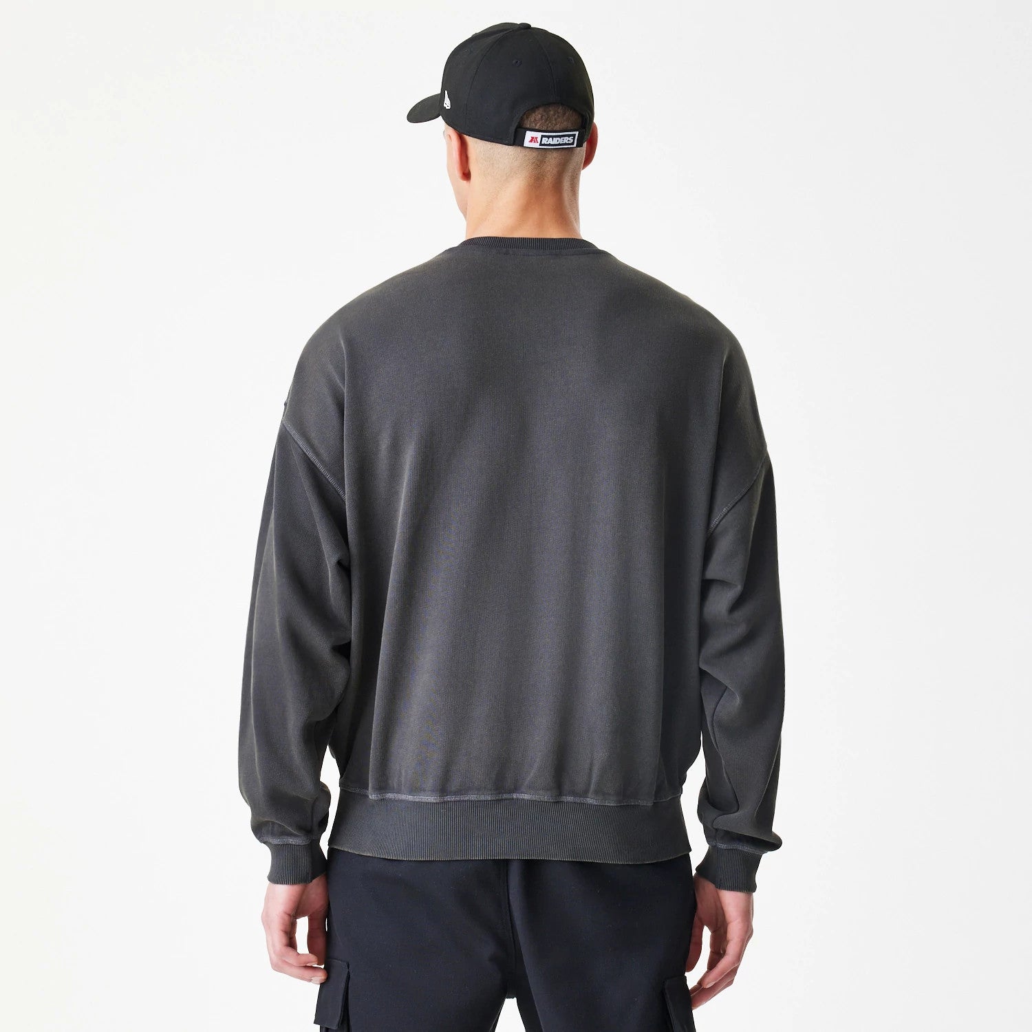 The Male model is wearing Las Vegas Raiders NFL Washed Boxy Dark Grey Oversized Crew Neck Sweater 2