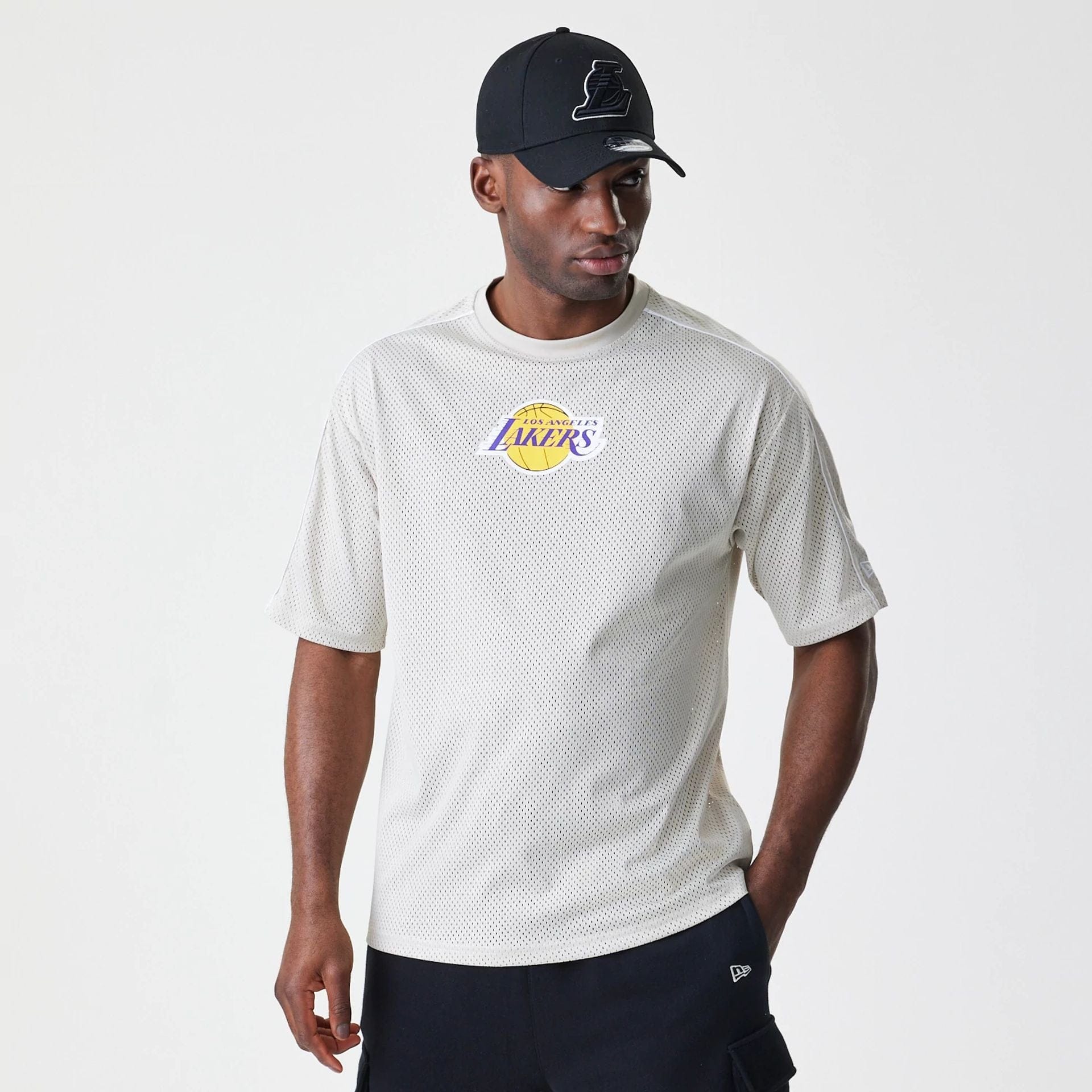 The Male model is wearing LA Lakers NBA Piping Light Beige Oversized Mesh T-Shirt 1