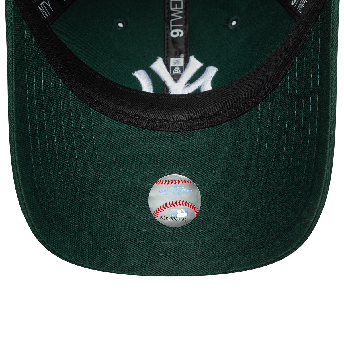 New York Yankees Womens MLB League Essential Dark Green New Era 9TWENTY Adjustable Cap, inside view showing the black sweatband, dark green undervisor with a round baseball-themed sticker, and white NY logo embroidery through the crown.
