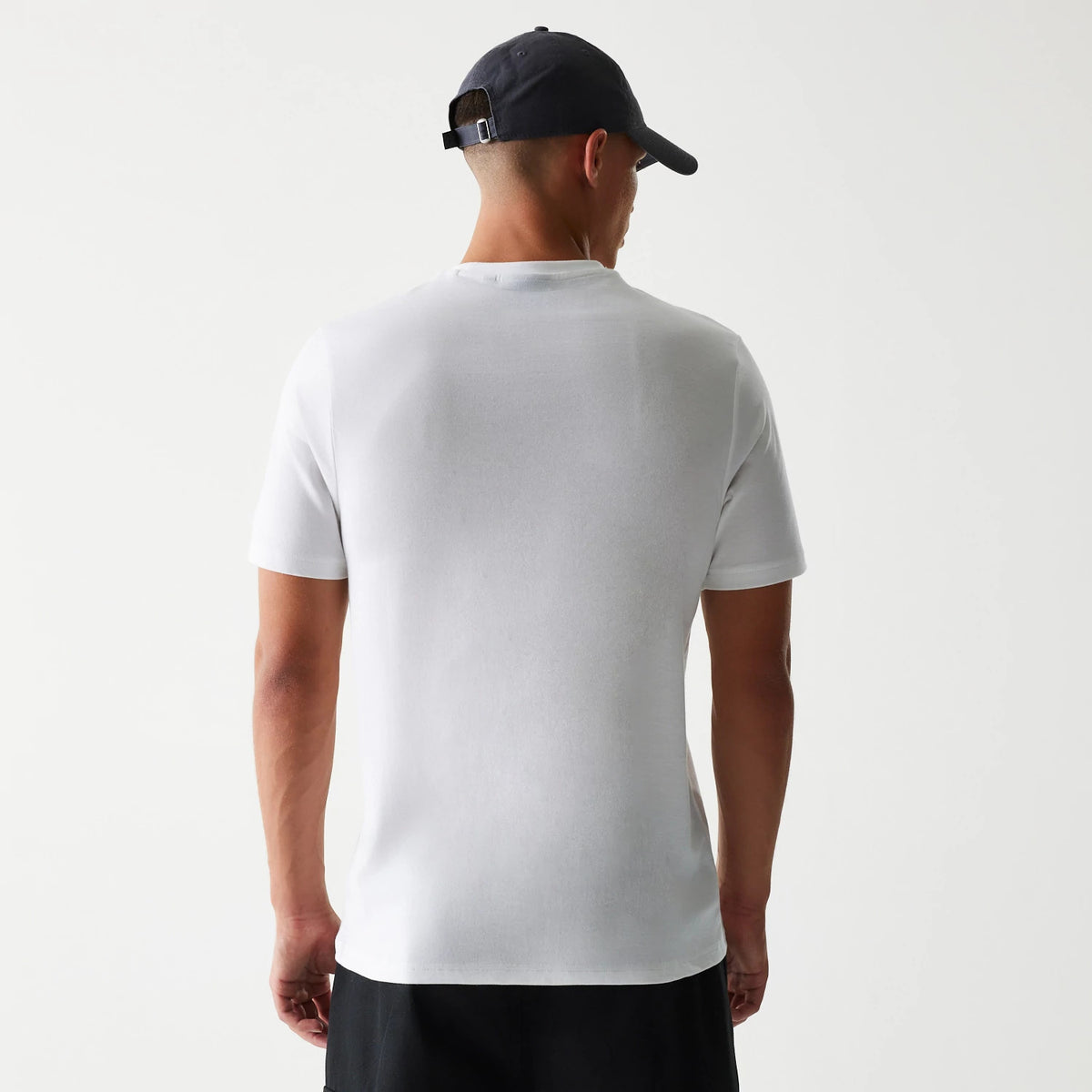 New Era New York Yankees MLB Baseball Graphic White T-Shirt, back view showing the plain white back of the T-shirt in a retail setting worn by a model, with short sleeves and a simple round neckline.