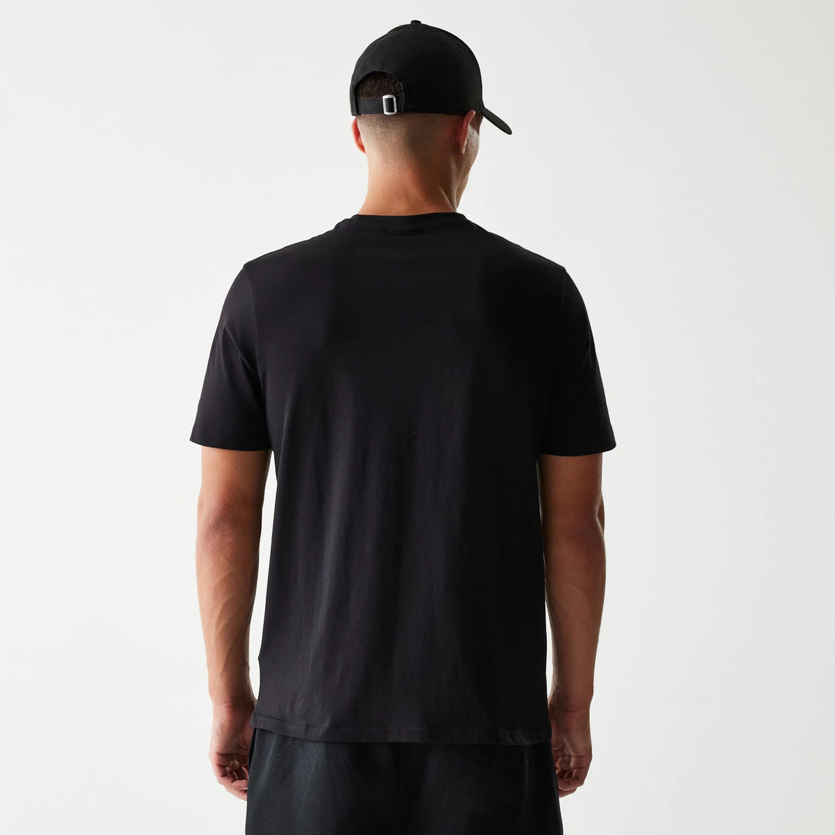 New Era LA Lakers NBA Flame Graphic Black T-Shirt, back view on a model styled with a plain black cap, showing a clean black surface with no graphics or text on the rear of the T-shirt.