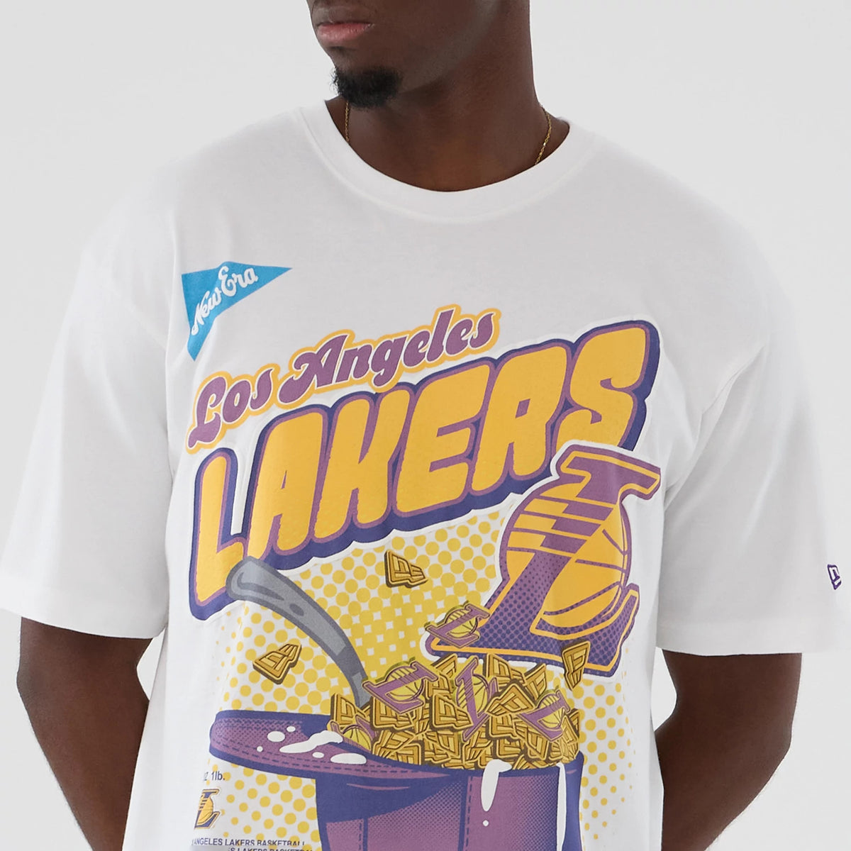 New Era LA Lakers NBA Lifestyle Graphic White T-Shirt, front view on-model showing a graphic with Los Angeles Lakers lettering in yellow and purple, a cereal bowl illustration, and an embroidered New Era logo on the sleeve.
