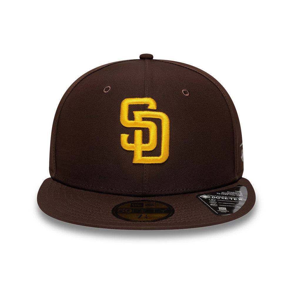 San Diego Padres MLB Gore-Tex Dark Brown New Era 59FIFTY Fitted Cap, front view showing the yellow SD logo in raised embroidery on the front panel, dark brown visor with a gold 59FIFTY size sticker, and white New Era flag logo on the left side.