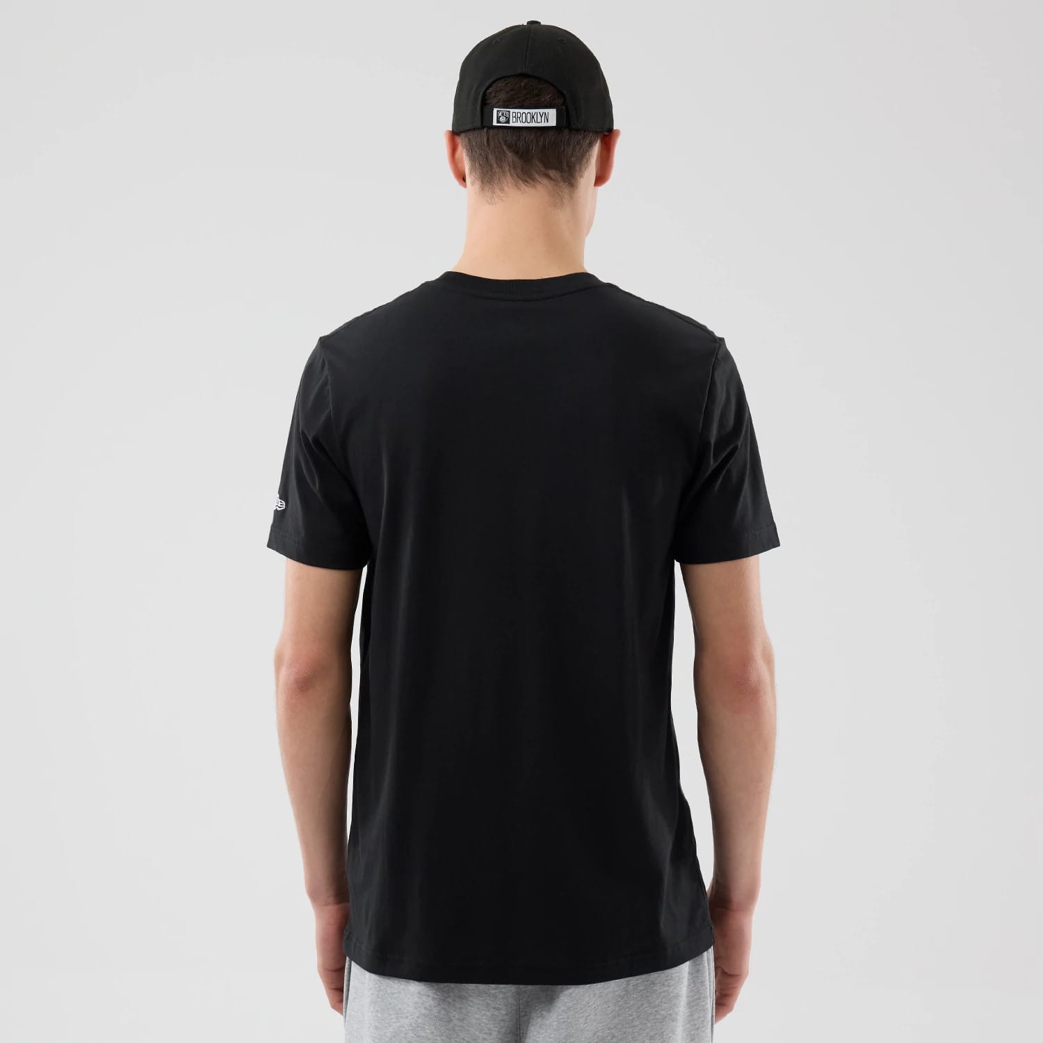 The Male model is wearing Brooklyn Nets NBA City Edition Black T-Shirt 2