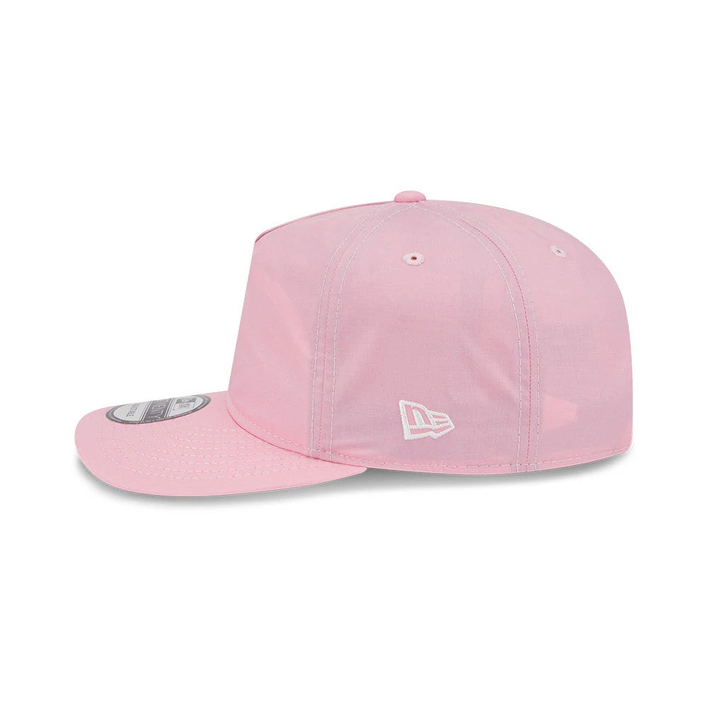 New Era Open Pink 19TWENTY Adjustable Cap, side view showing the white embroidered New Era flag logo on the left side, with a flat visor and an open pink structured crown featuring matching eyelets and a top button.