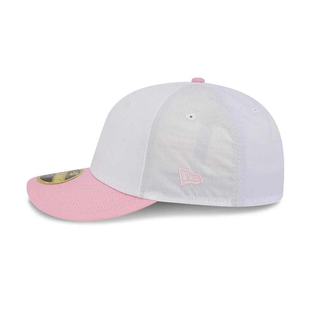 New Era Open White & Pink Low Profile 59FIFTY Fitted Cap, side view with a light pink embroidered New Era flag logo on the left side, a curved pink visor, and a gold 59FIFTY size sticker on the top.