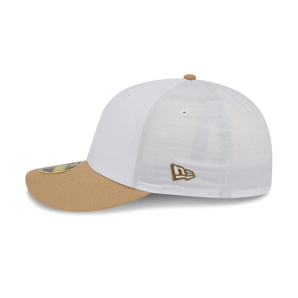 New Era Open White & Beige Low Profile 59FIFTY Fitted Cap, side view showing the embroidered New Era flag logo in beige on the white structured crown, with a beige curved visor and 59FIFTY size sticker.