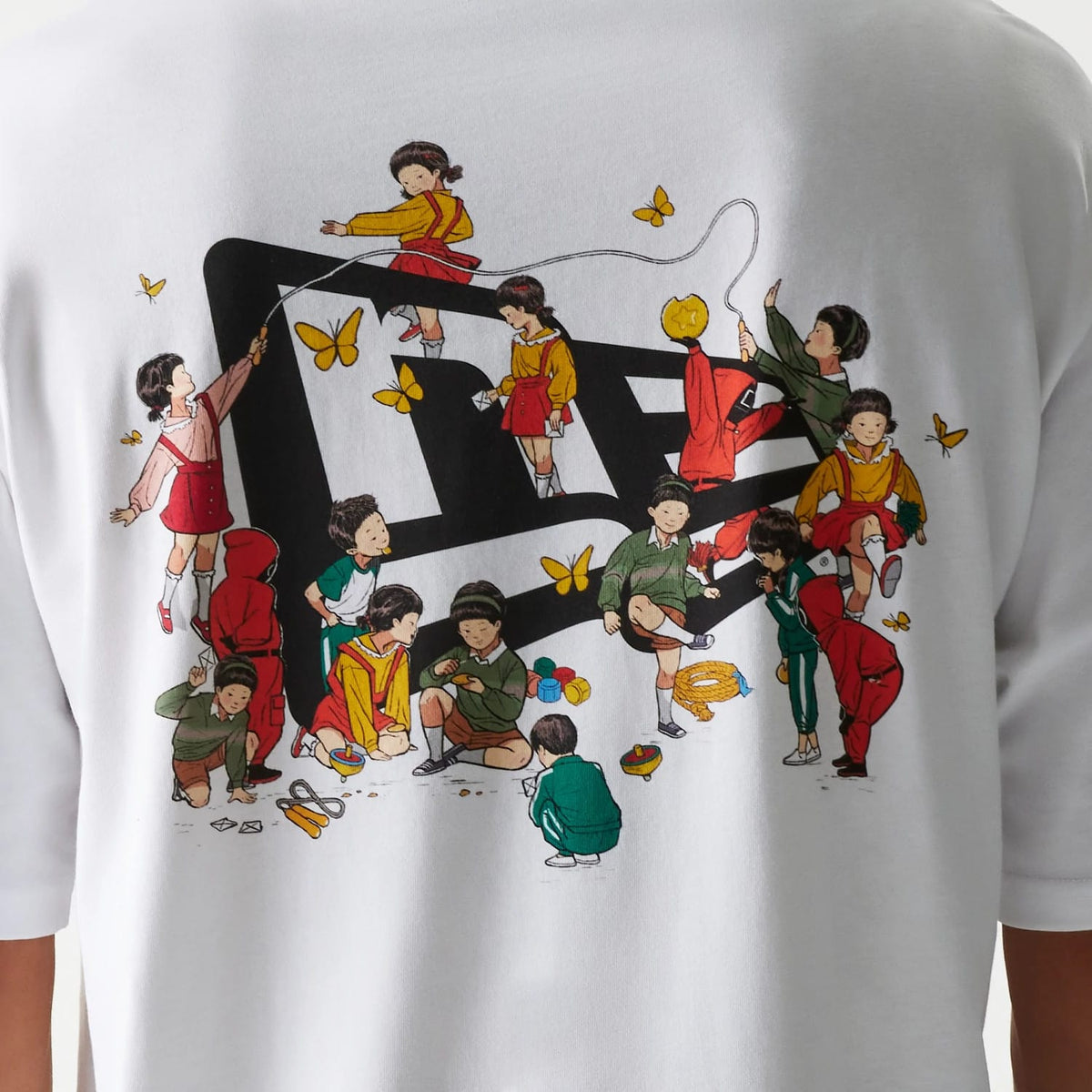 New Era Netflix Squid Game White Oversized T-Shirt, back view showing an illustration of children playing around a large printed New Era logo, with colours and scattered yellow butterflies adding detail.