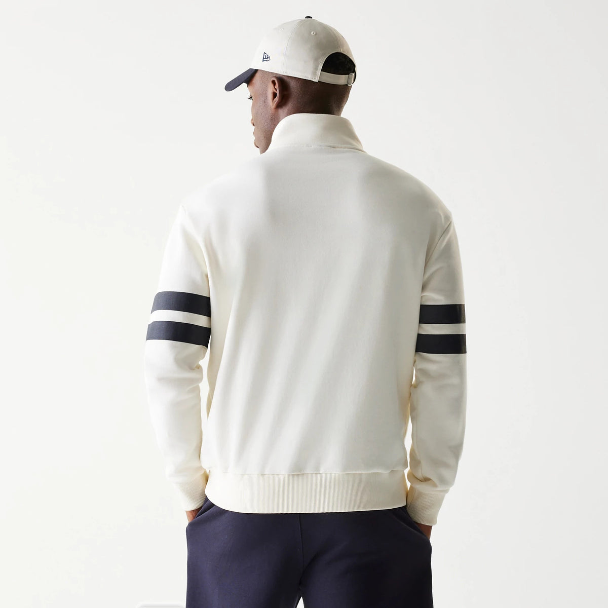 New Era Open White Oversized 1/4 Zip Sweater, back view with contrasting dark double stripes on the sleeves and a high collar, showcasing the slightly loose fit and ribbed cuffs and hem.