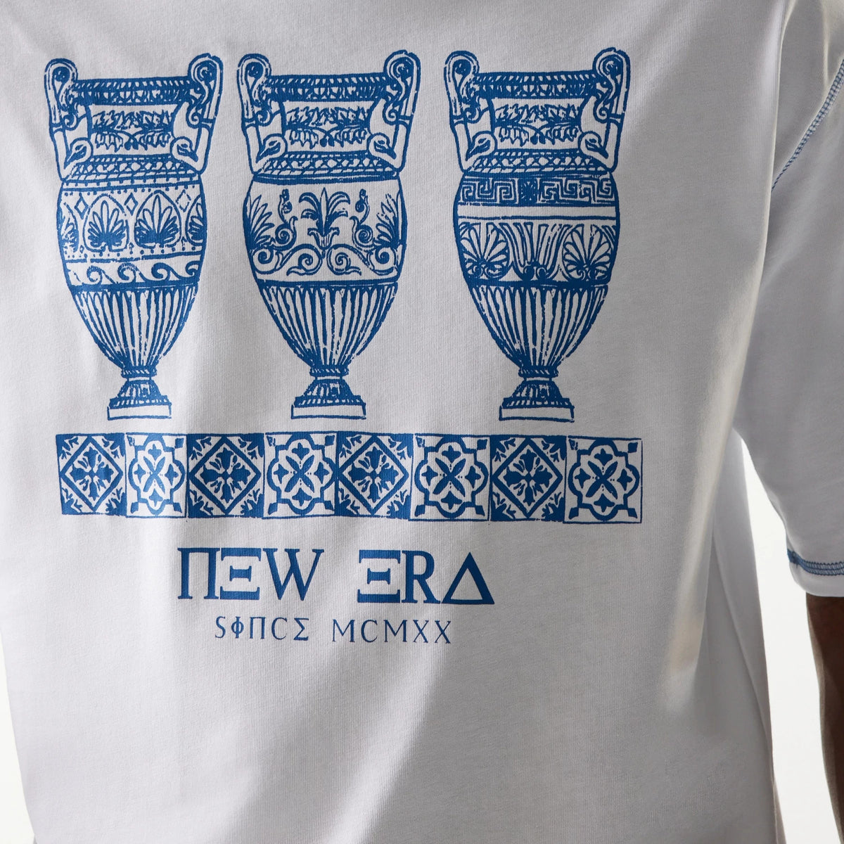 New Era Orthodox Vase White Oversized T-Shirt, back view showing a detailed blue graphic of three vases and geometric patterns across the upper back, with New Era Greek-style lettering printed near the bottom.