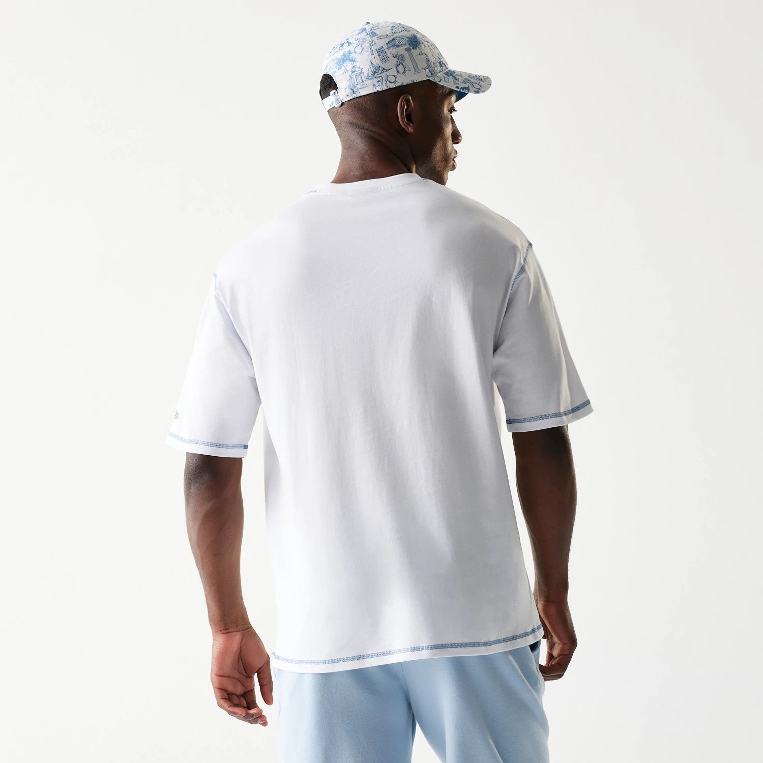 The Male model is wearing New Era Orthodox Vase White Oversized T-Shirt 2