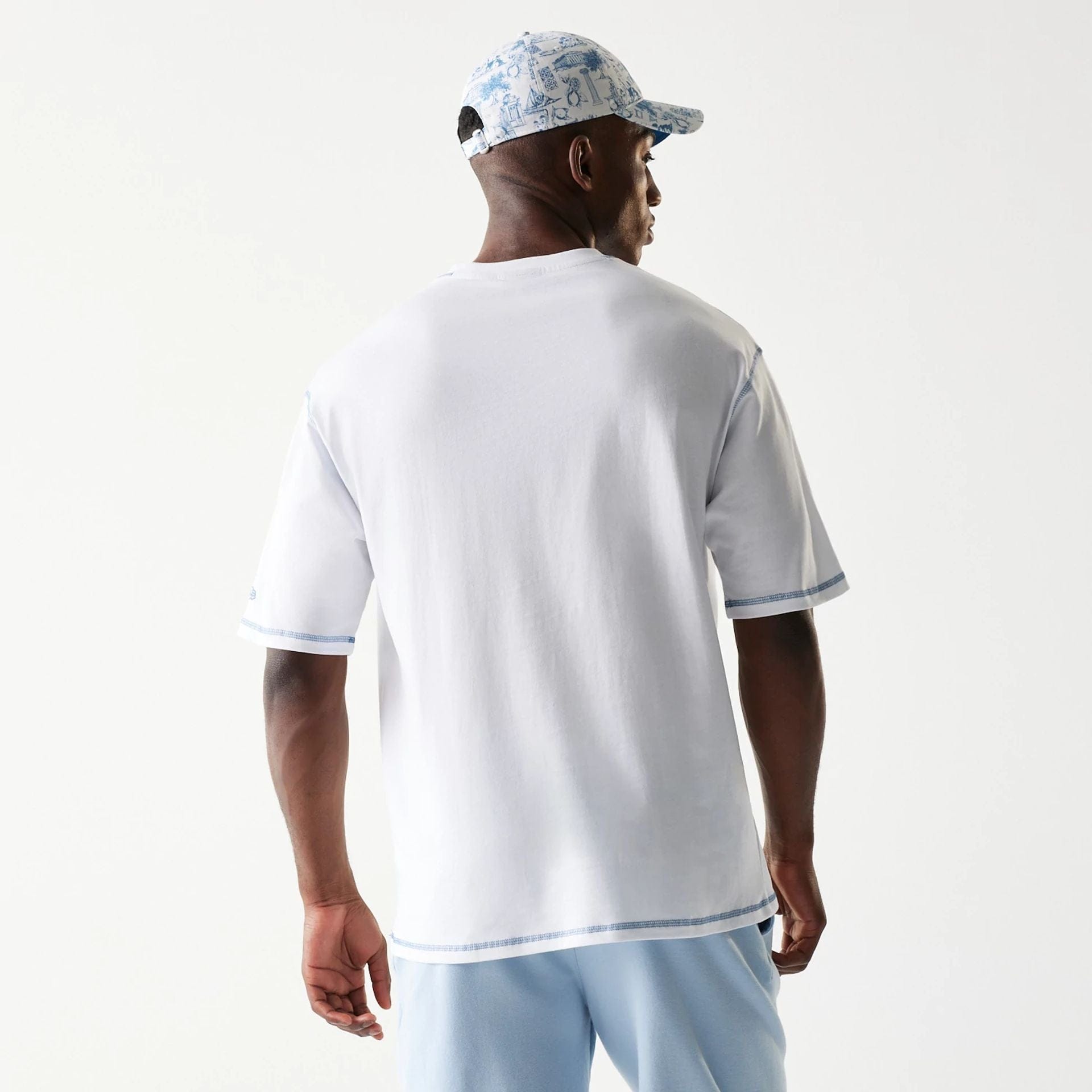The Male model is wearing New Era Orthodox Vase White Oversized T-Shirt 2