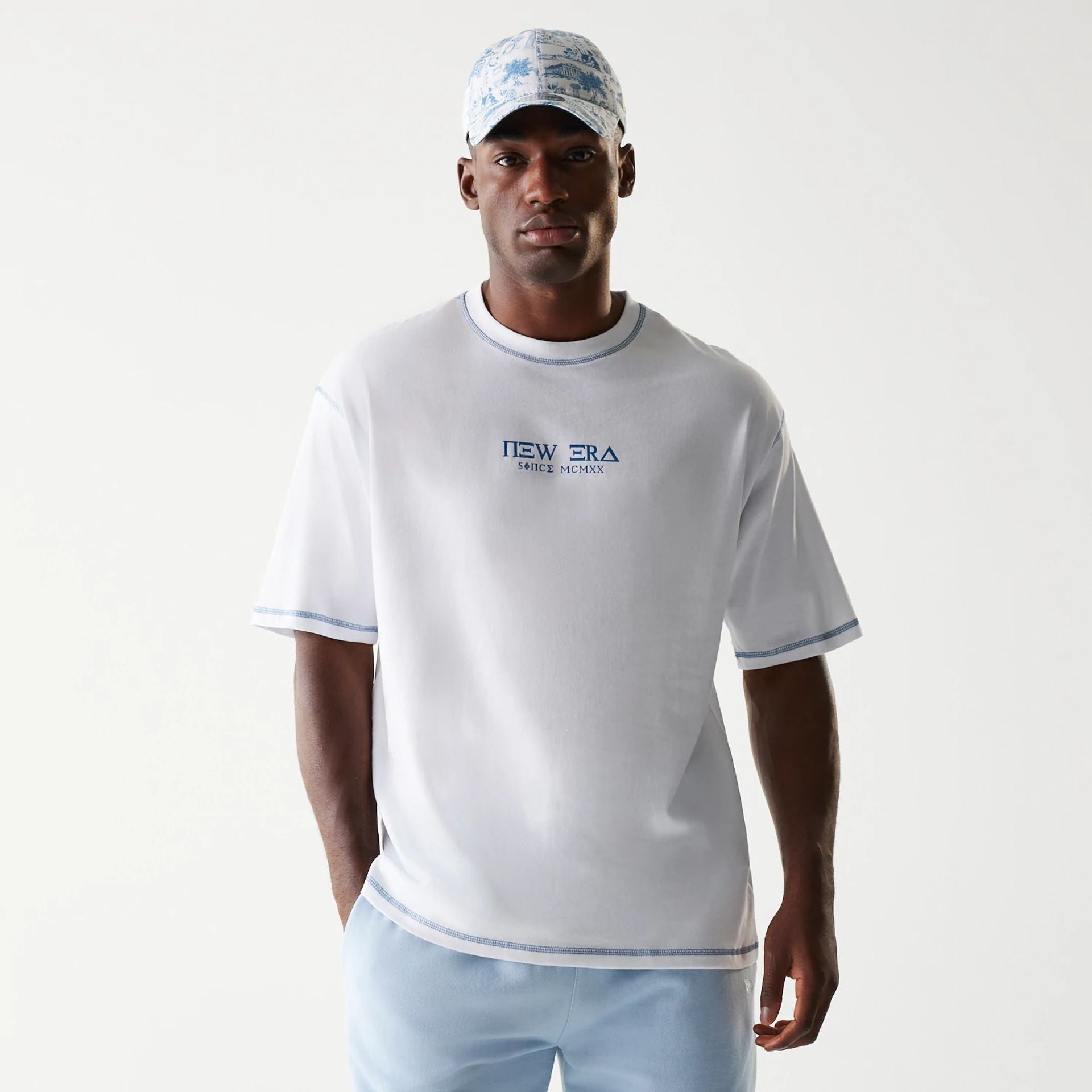 The Male model is wearing New Era Orthodox Church White Oversized T-Shirt 1
