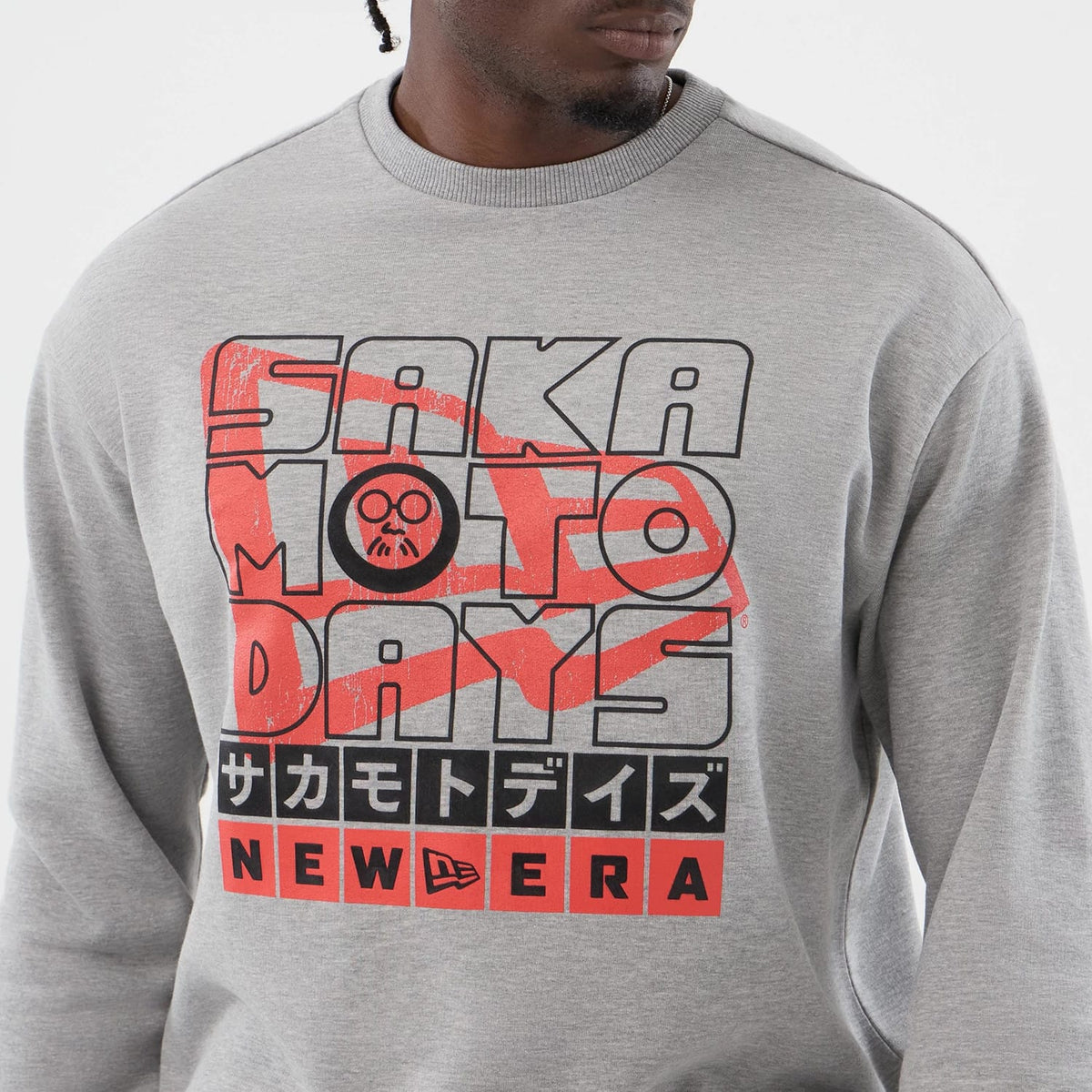 New Era Sakamoto Days Netflix Grey Crew Neck Sweater, front view on a model with Sakamoto Days text and graphics in red and black across the chest, featuring the New Era logo at the bottom centre.