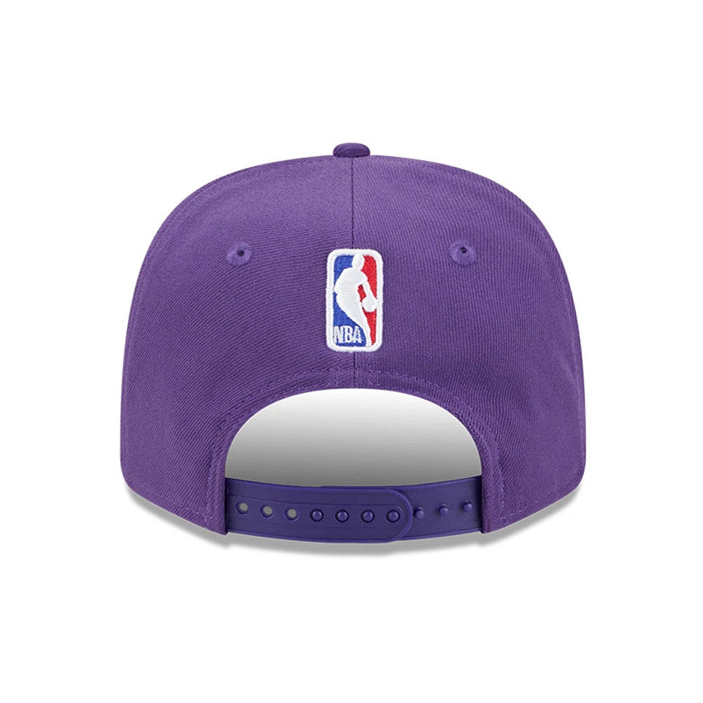 LA Lakers NBA Statement Purple New Era 9SEVENTY Stretch Snap Adjustable Cap, rear view showing the embroidered NBA logo at the centre above the adjustable snap closure on the structured purple crown.