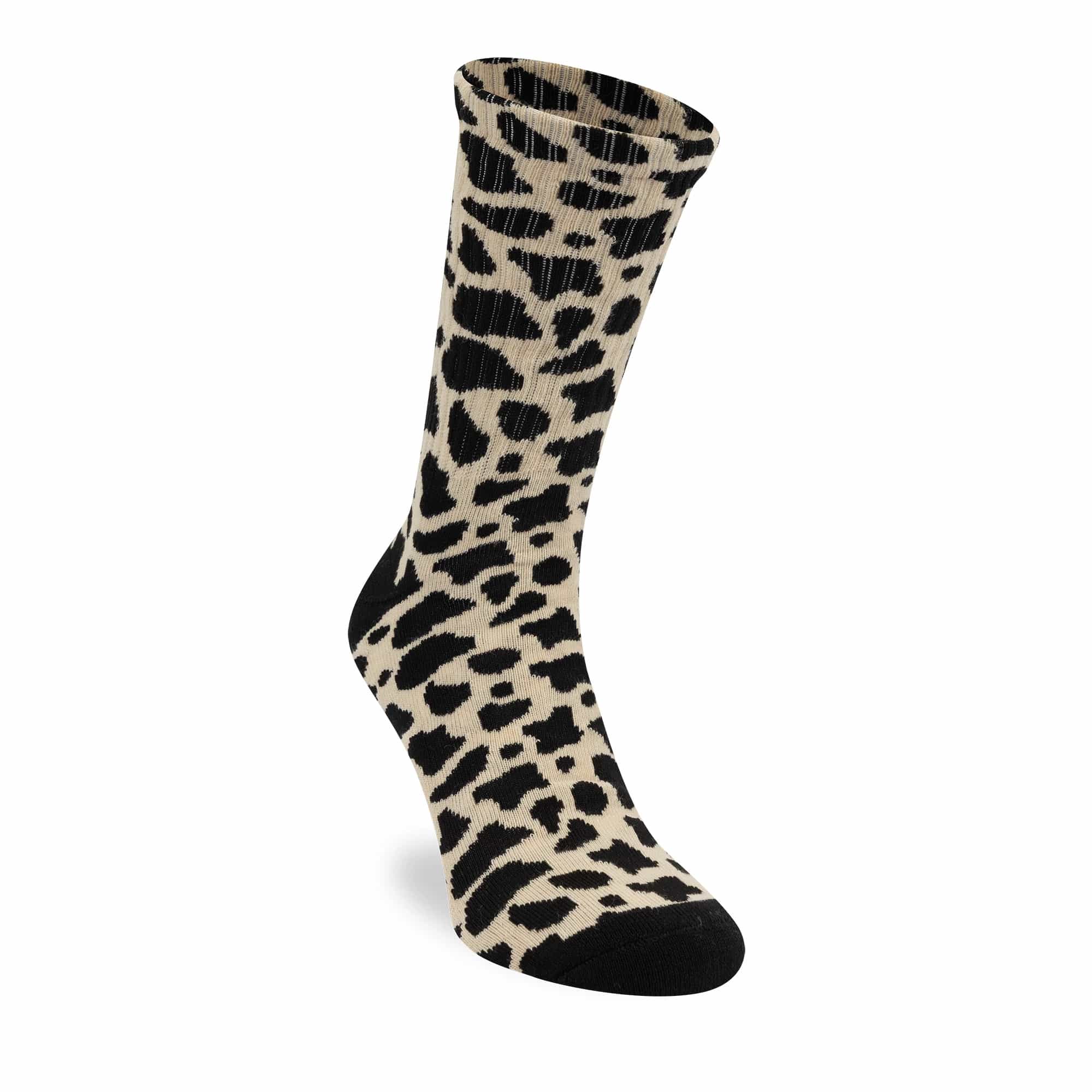 New Era New York Yankees MLB Cow Black Crew Socks, three-quarter view showing a beige sock with black cow print, black heel and toe, and a small embroidered New Era logo near the top edge.