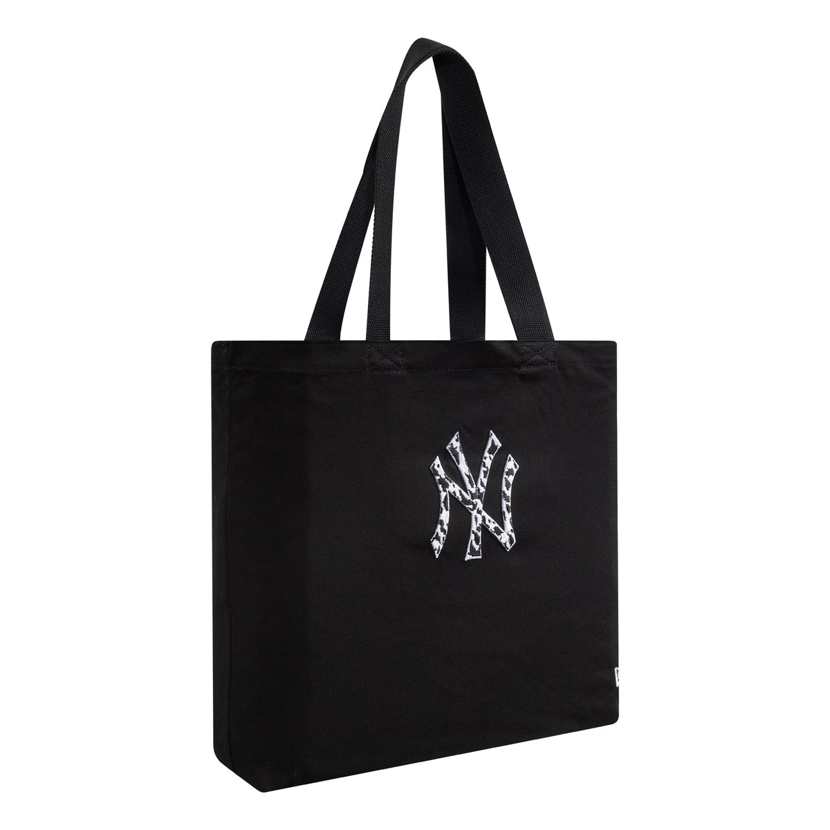 New Era New York Yankees MLB Animal Infill Black Tote Bag, side view displaying the black structure with twin handles and an embroidered New York Yankees logo featuring an animal print pattern in the centre.
