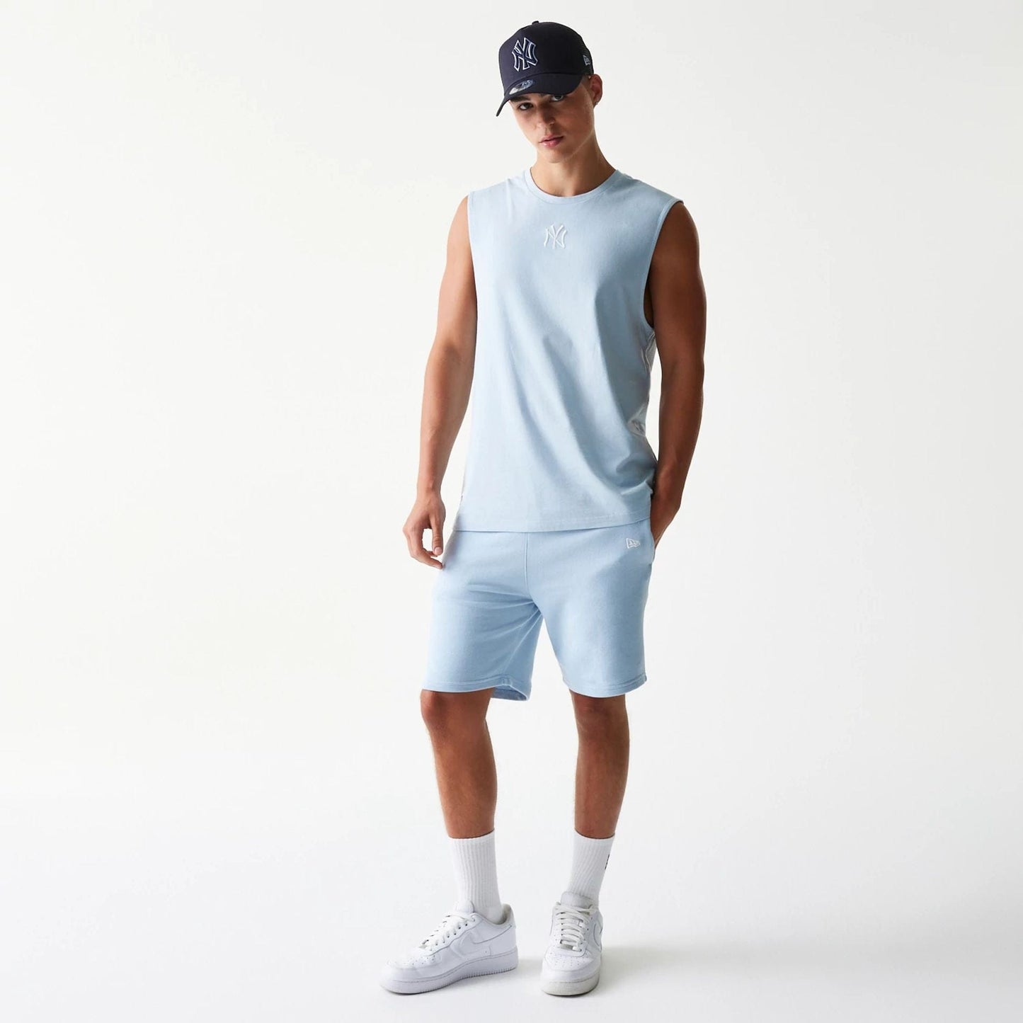 The model is wearing this MLB League Essential New York Yankees Sleeveless T-Shirt in pastel blue. 8