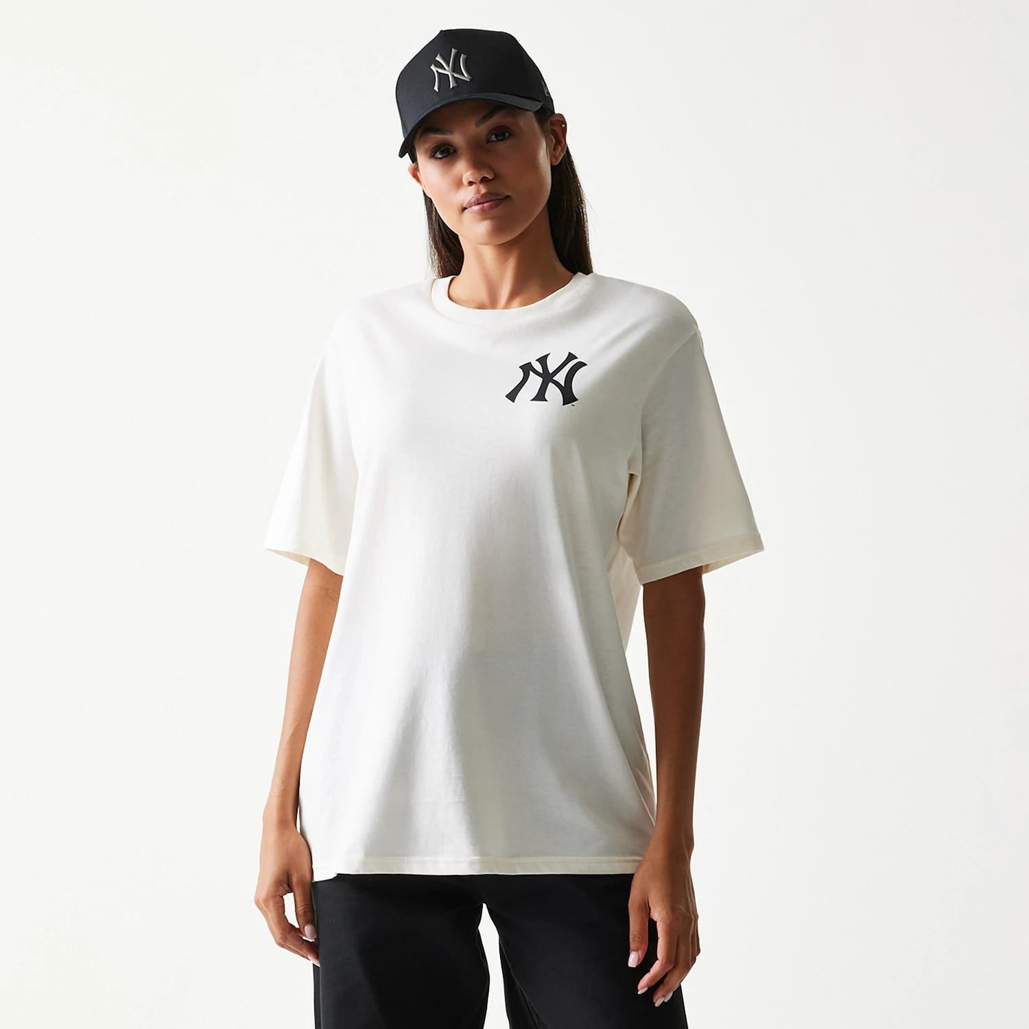 New Era New York Yankees MLB Food Graphic Open White T-Shirt, front view on-model showing a large black embroidered Yankees logo on the left chest, paired with a cap also featuring the Yankees logo for a coordinated look.