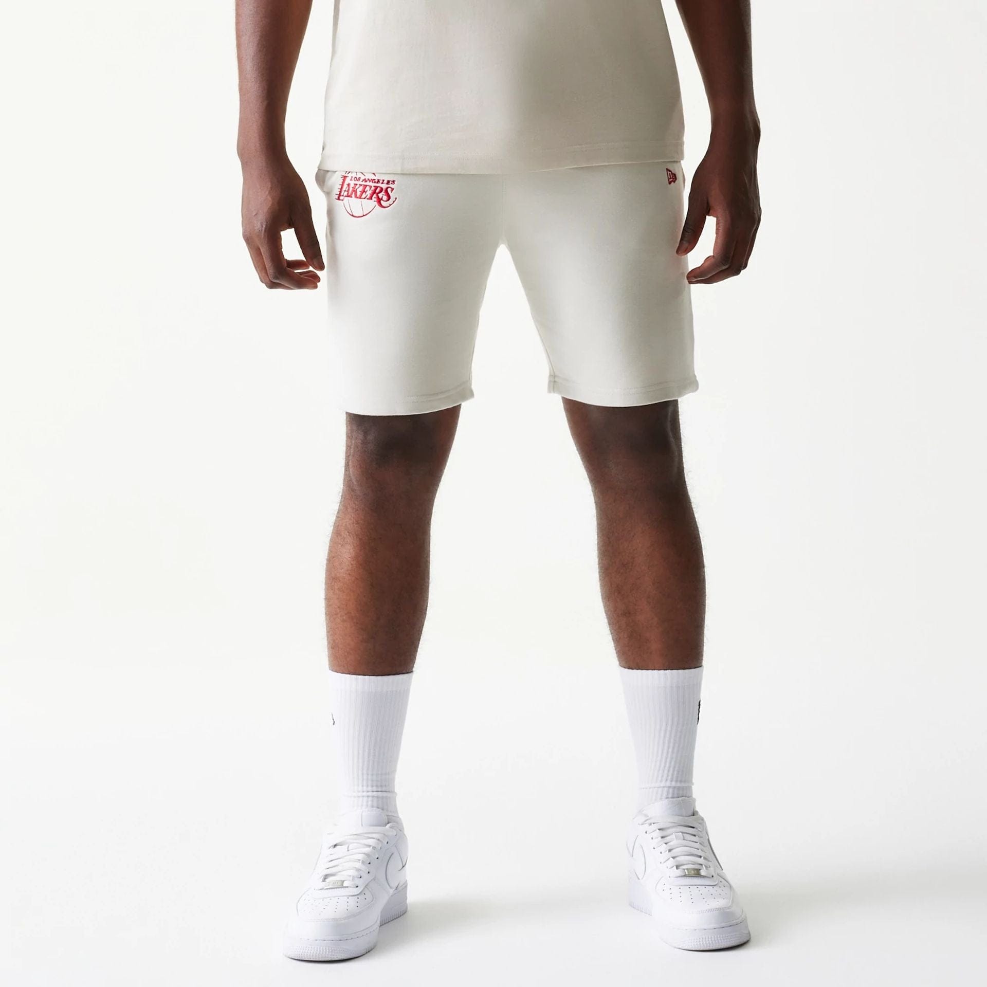 The model is wearing this NBA League Essential LA Lakers Shorts in cream. 1