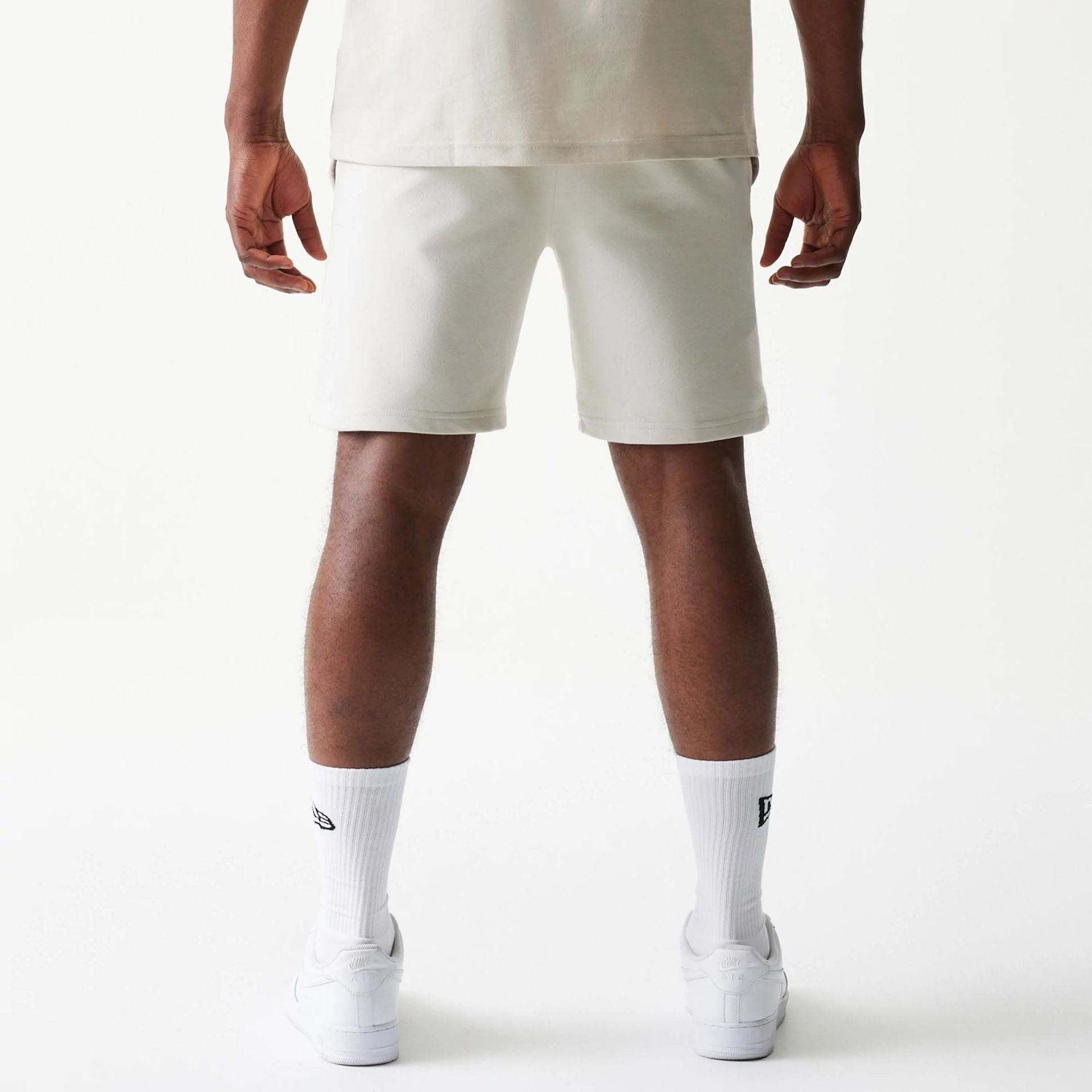 The model is wearing this NBA League Essential LA Lakers Shorts in cream. 2