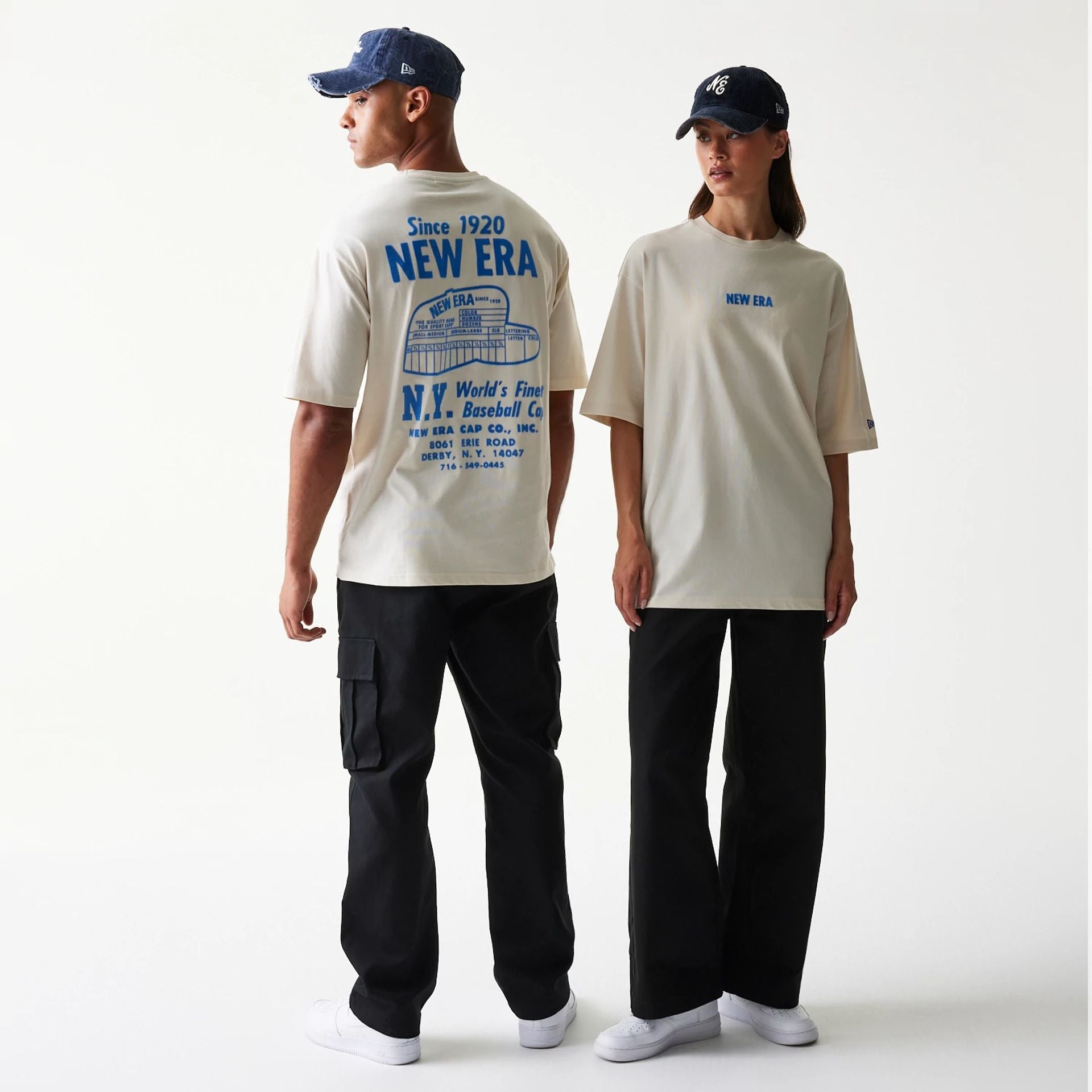 The model is wearing this New Era Graphic Oversized T-Shirt in light beige. 1