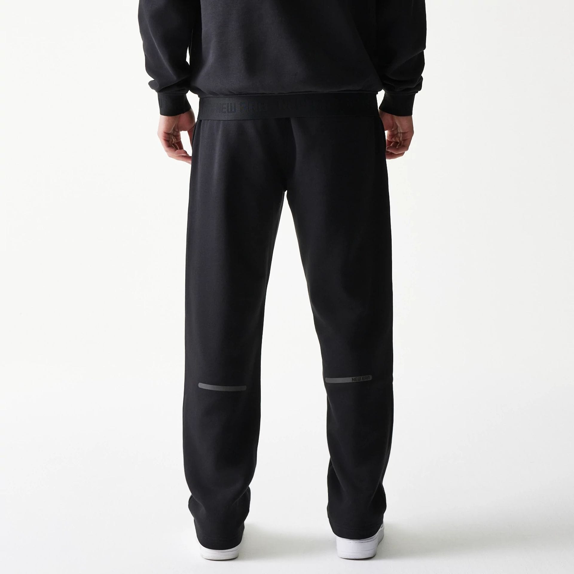 The model is wearing this New Era Tech Straight Leg Joggers in black. 2