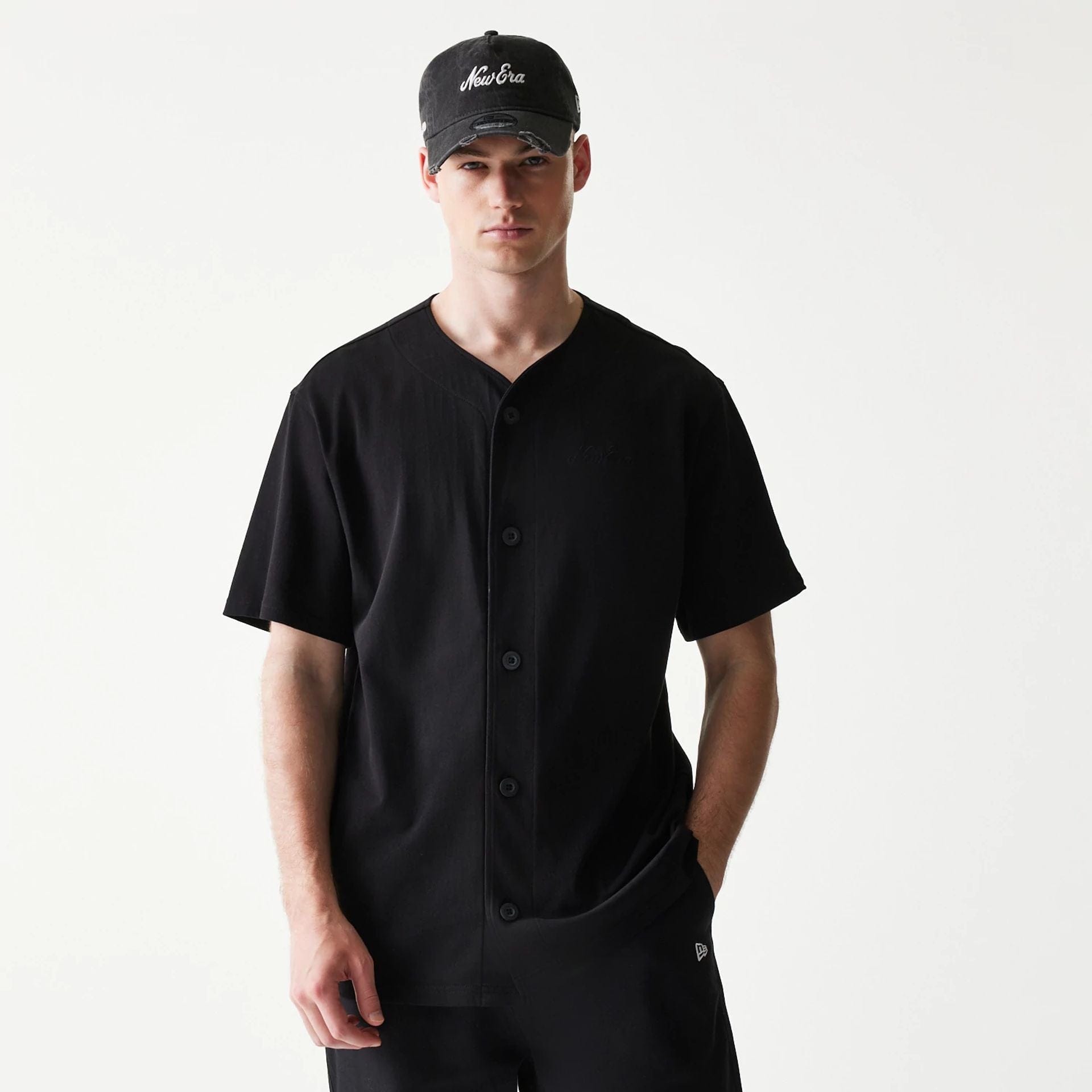 The model is wearing this New Era Script T-Shirt in black. 1