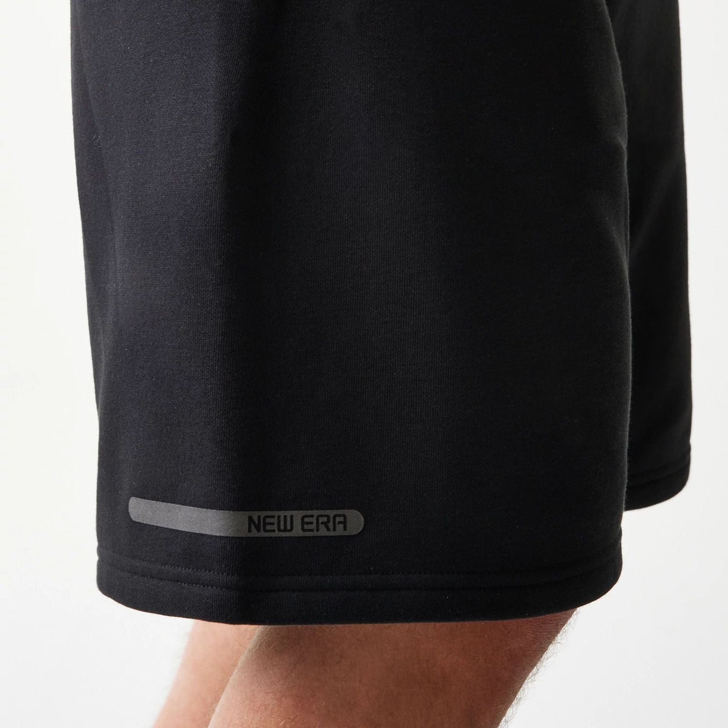 The model is wearing this New Era Tech Shorts in black. 8