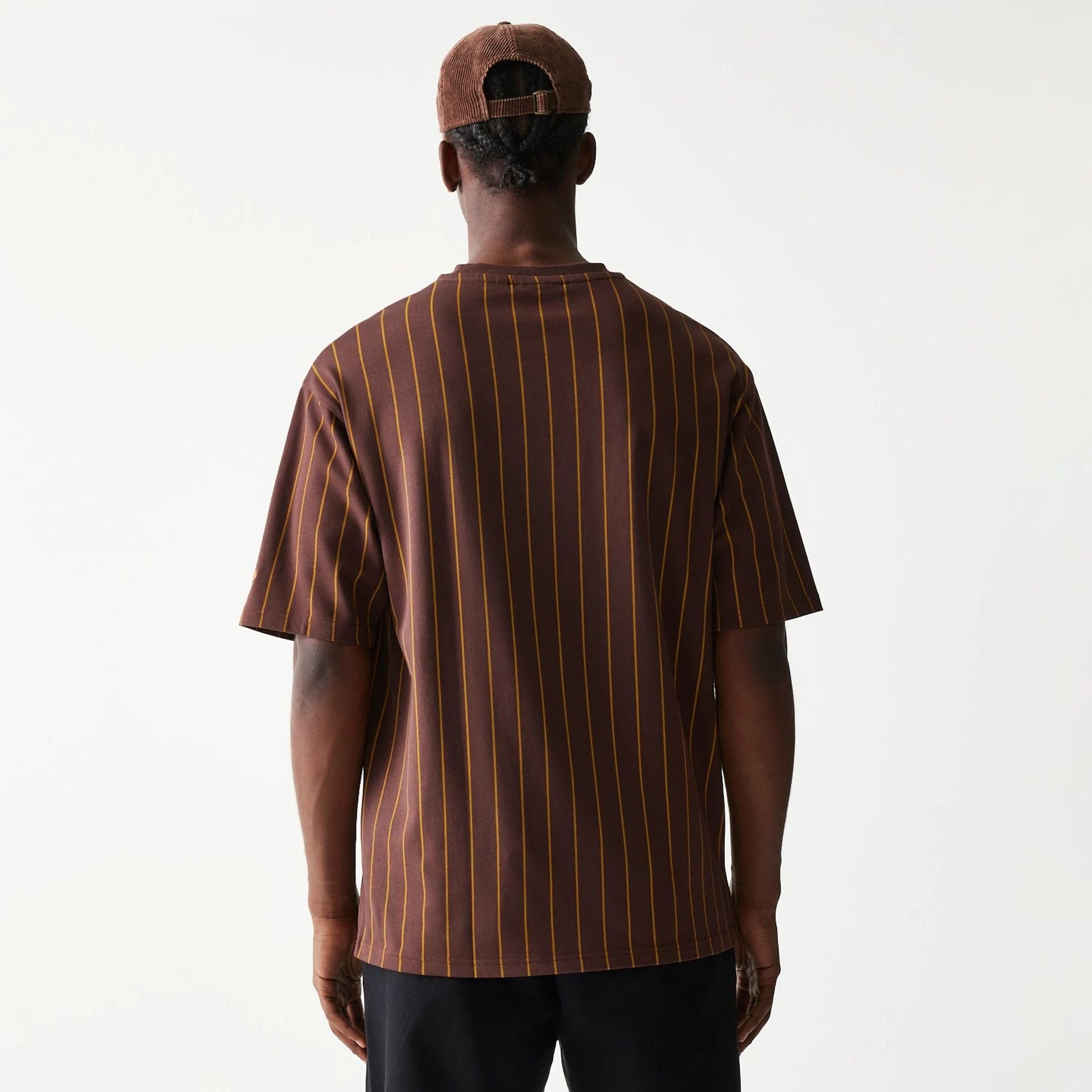 The model is wearing this New Era Pinstripe Oversized T-Shirt in brown. 2