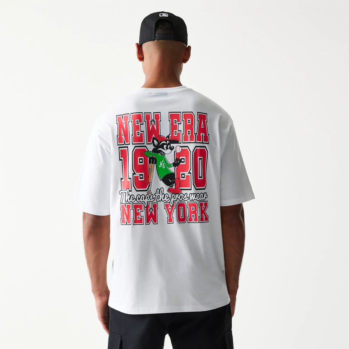 New Era Baseball Cat Character Graphic White Oversized T-Shirt, back view on-model highlighting red New Era 1920 lettering, a cartoon cat graphic in green, and New York text at the bottom.