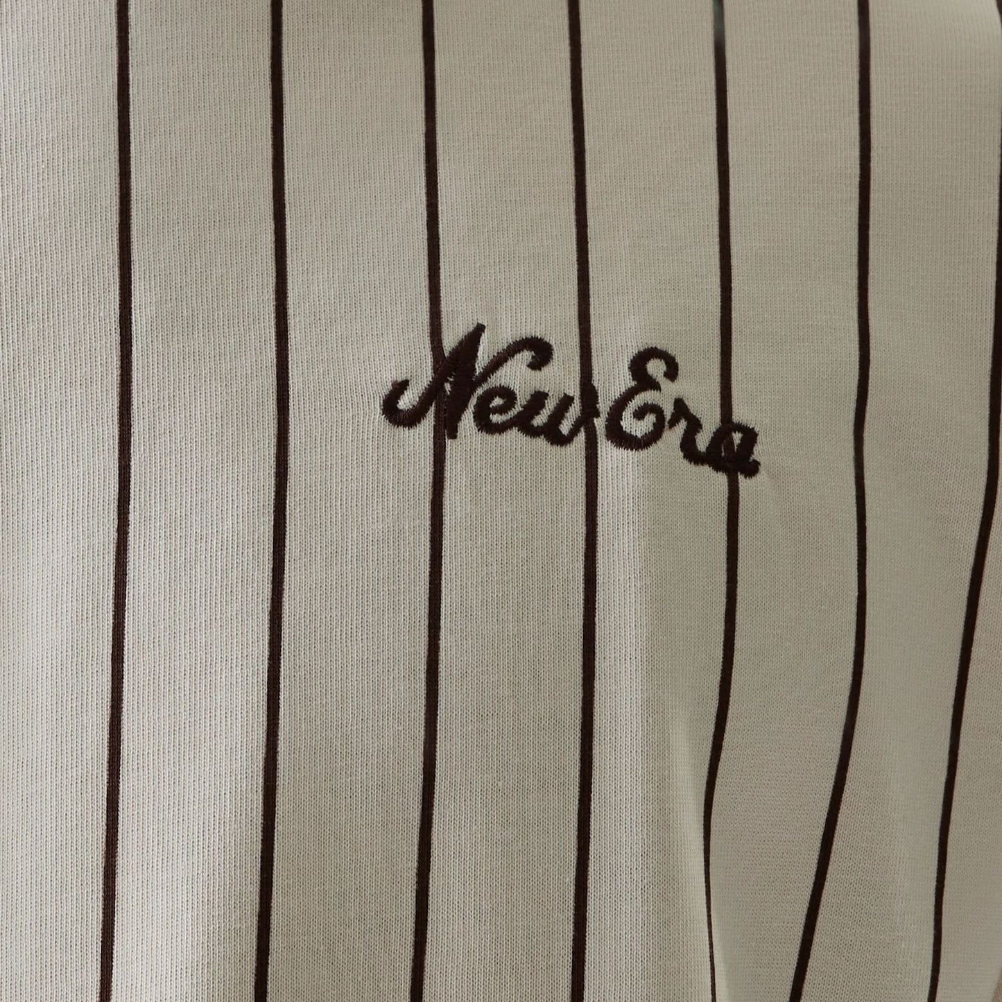 The model is wearing this New Era Pinstripe Oversized T-Shirt in light beige. 8