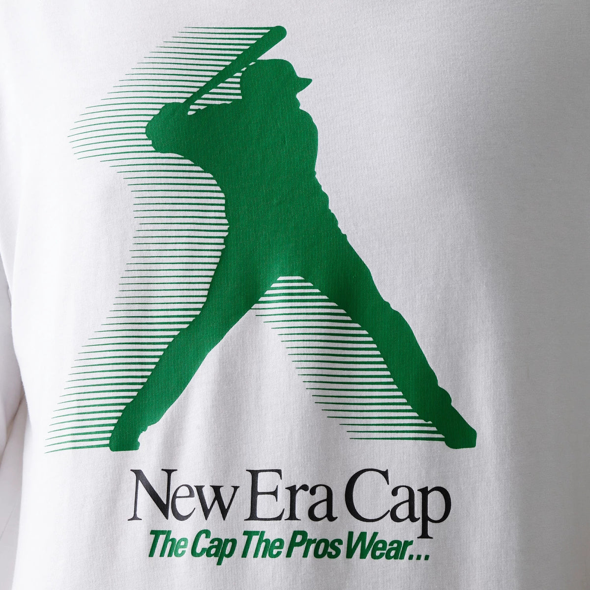 New Era Baseball Player Graphic White Oversized T-Shirt, front view featuring a large green printed graphic of a baseball player with a bat and stylised stripes, and the New Era Cap branding with the slogan The Cap The Pros Wear below.
