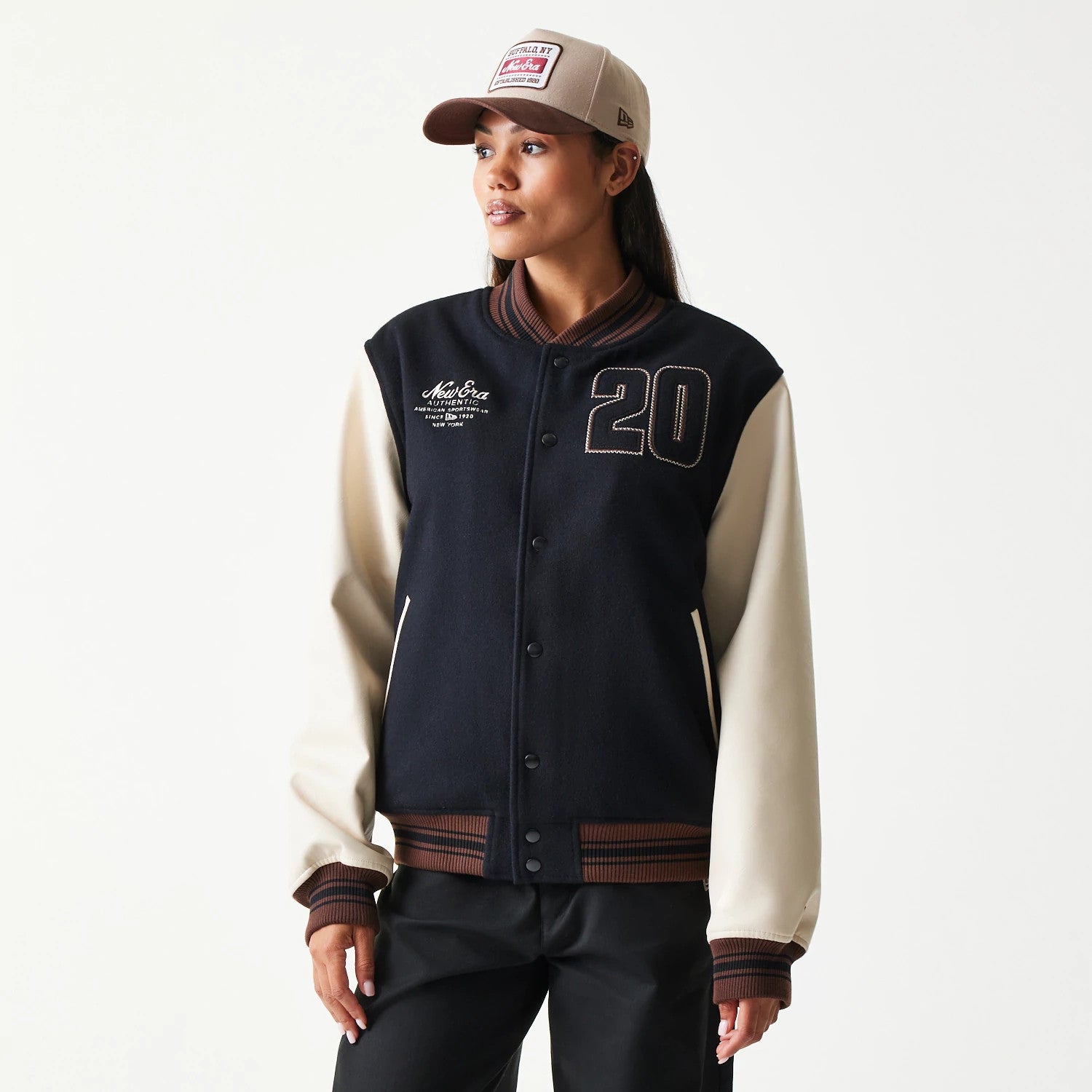 The model is wearing this New Era Varsity Jacket in black. 4