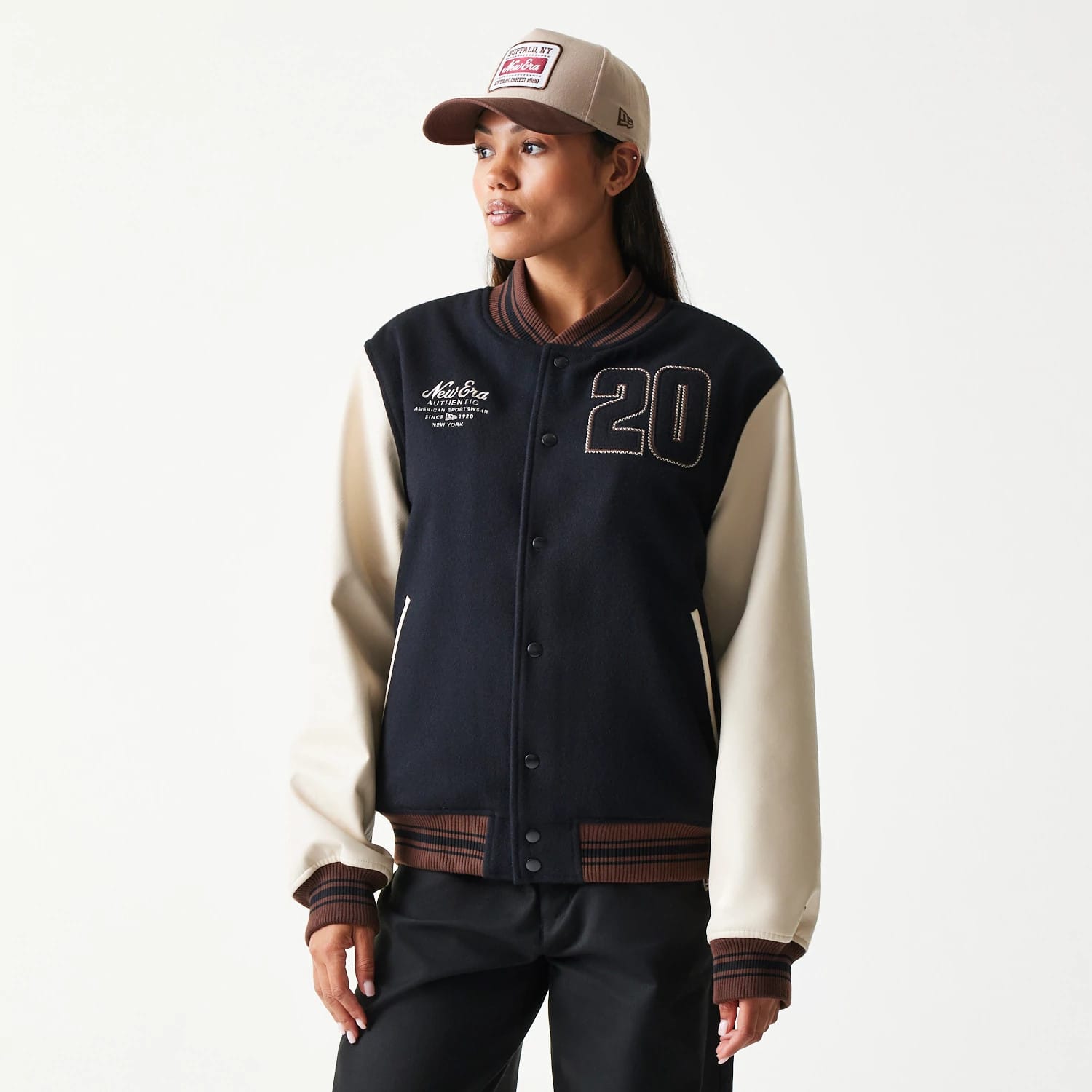 The model is wearing this New Era Varsity Jacket in black. 4