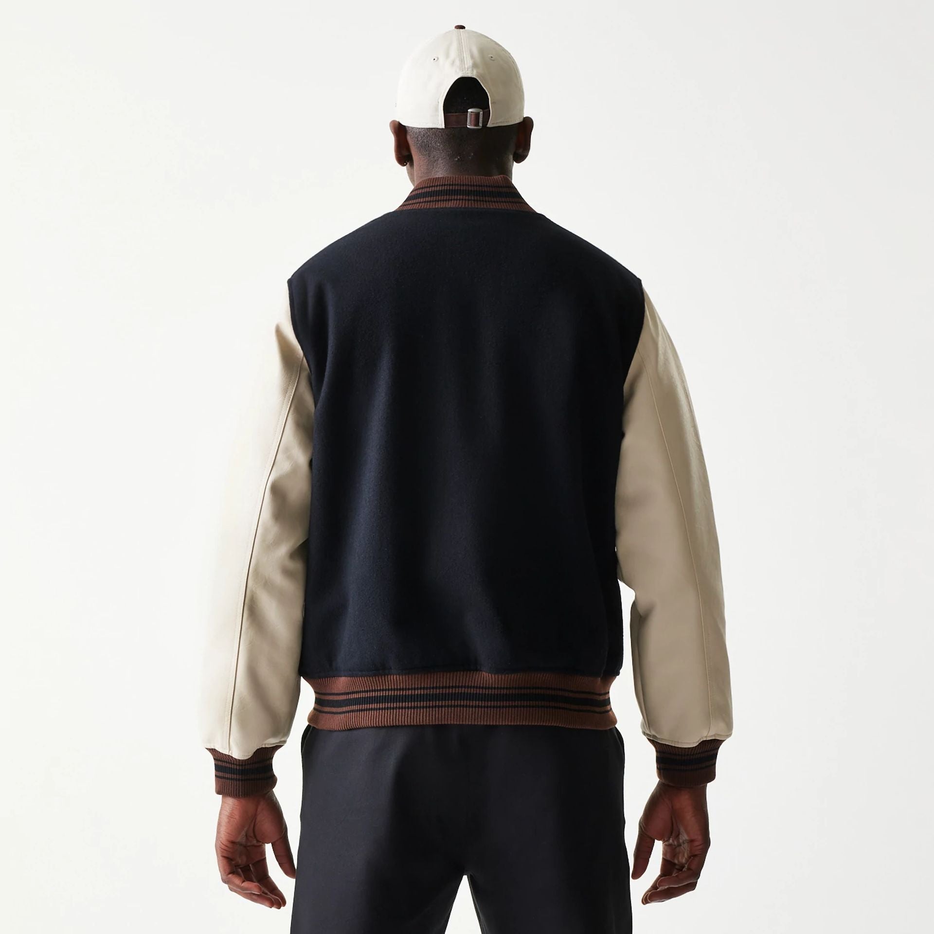 The model is wearing this New Era Varsity Jacket in black. 2