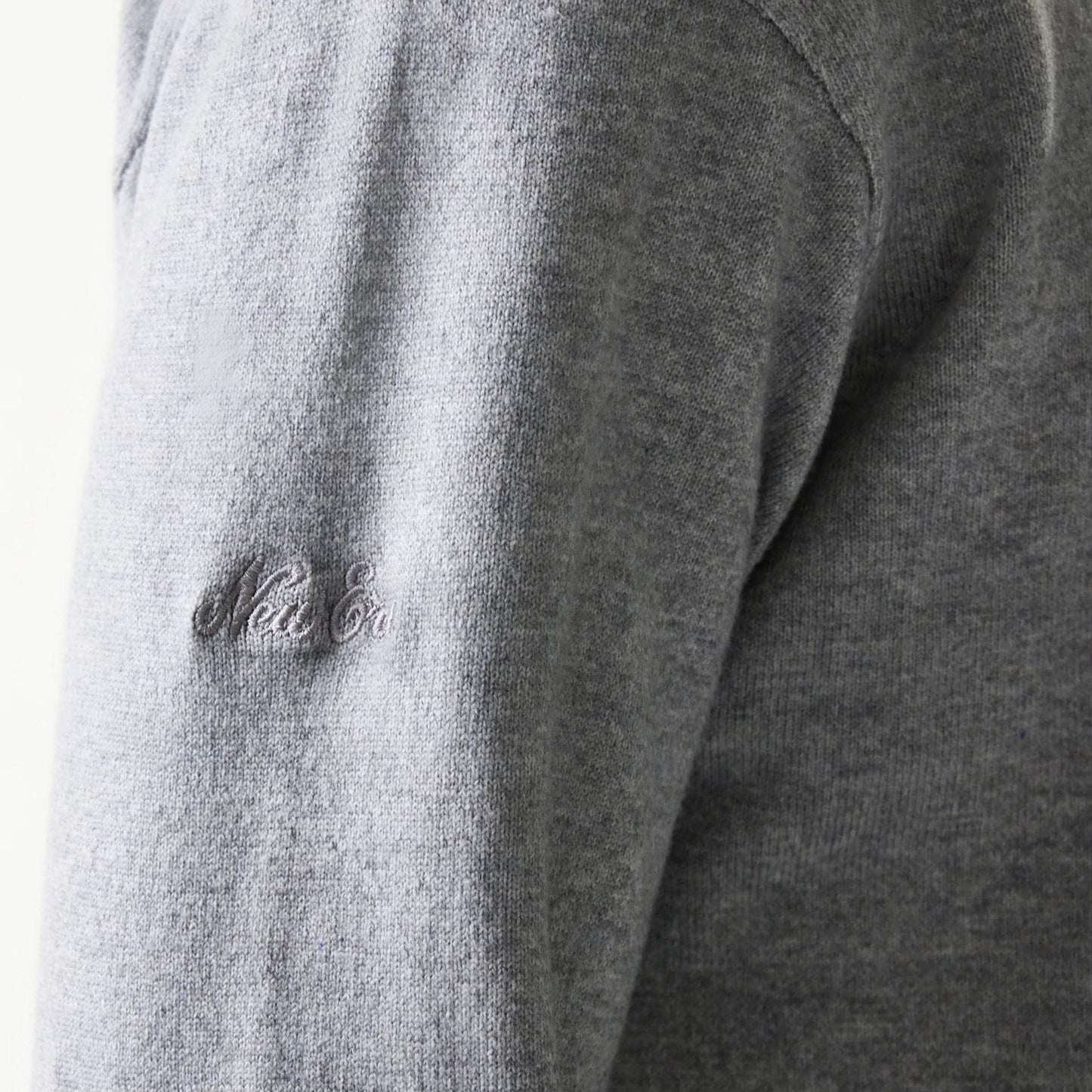 The model is wearing this New Era Essential Flag Knitted Sweater in grey. 8