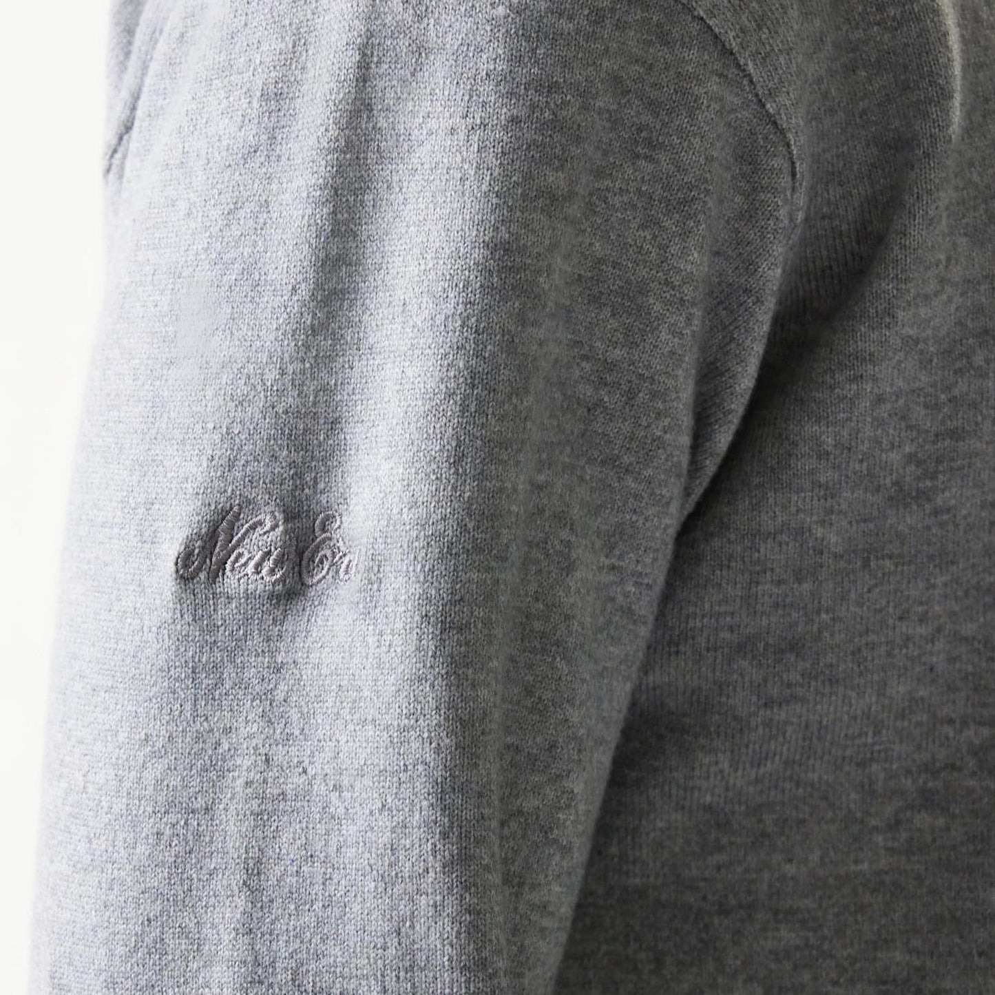 The model is wearing this New Era Essential Flag Knitted Sweater in grey. 8