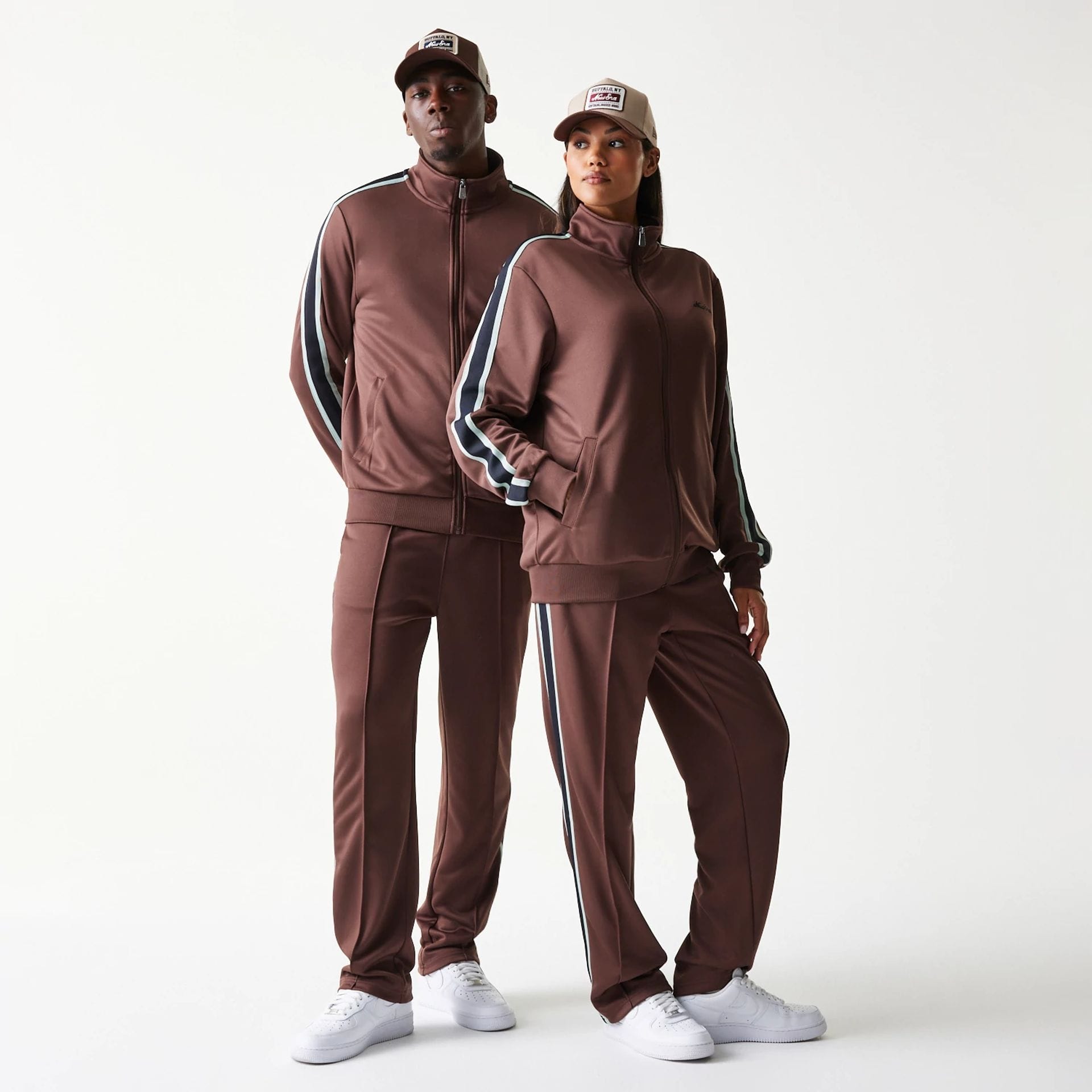 The model is wearing this New Era Script Track Jacket in brown. 1