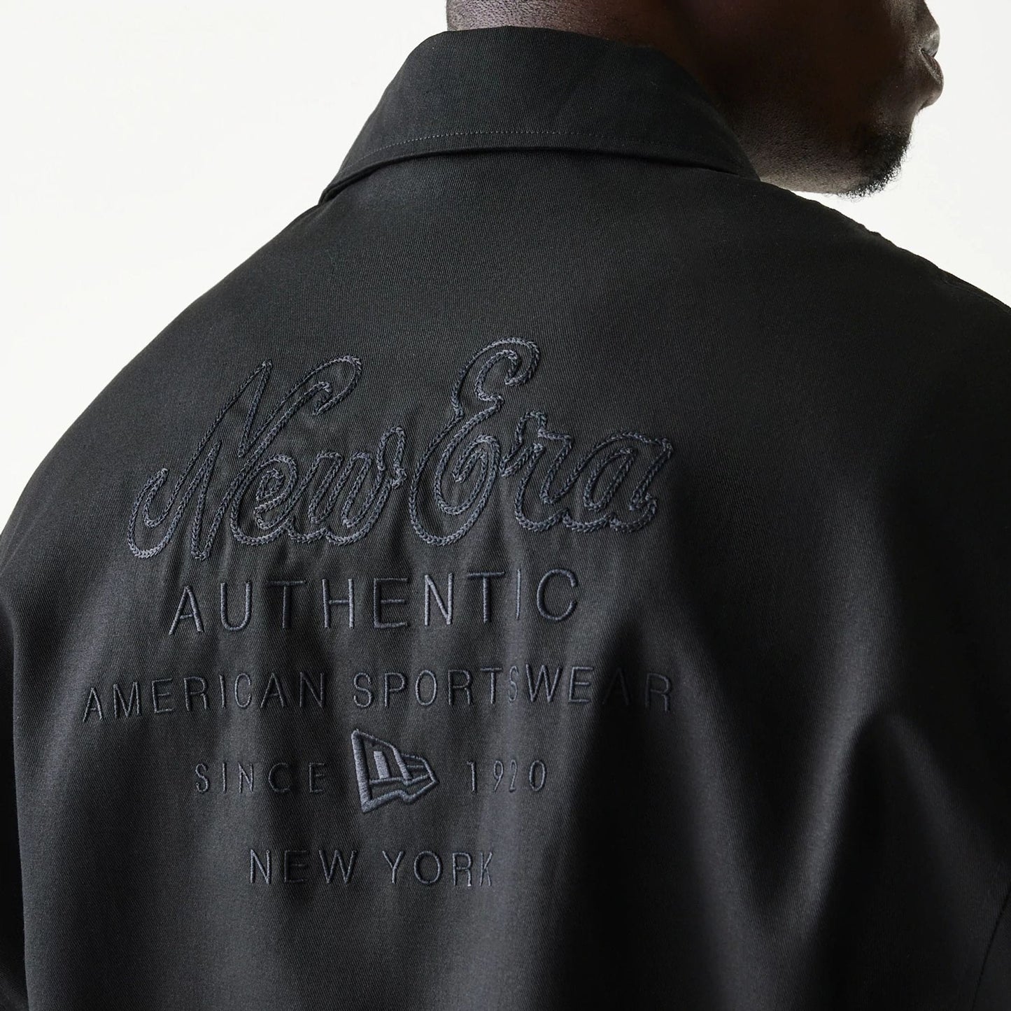 The model is wearing this New Era Collared Jacket in black. 8