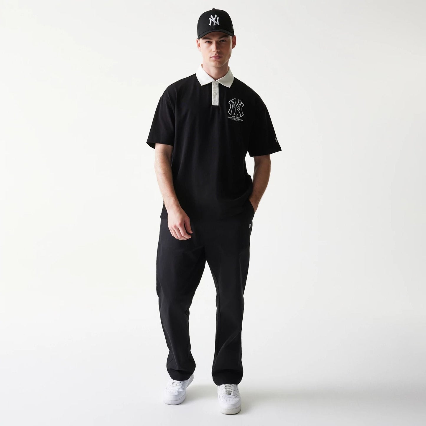 The model is wearing this MLB New York Yankees Oversized Polo T-Shirt in black. 8