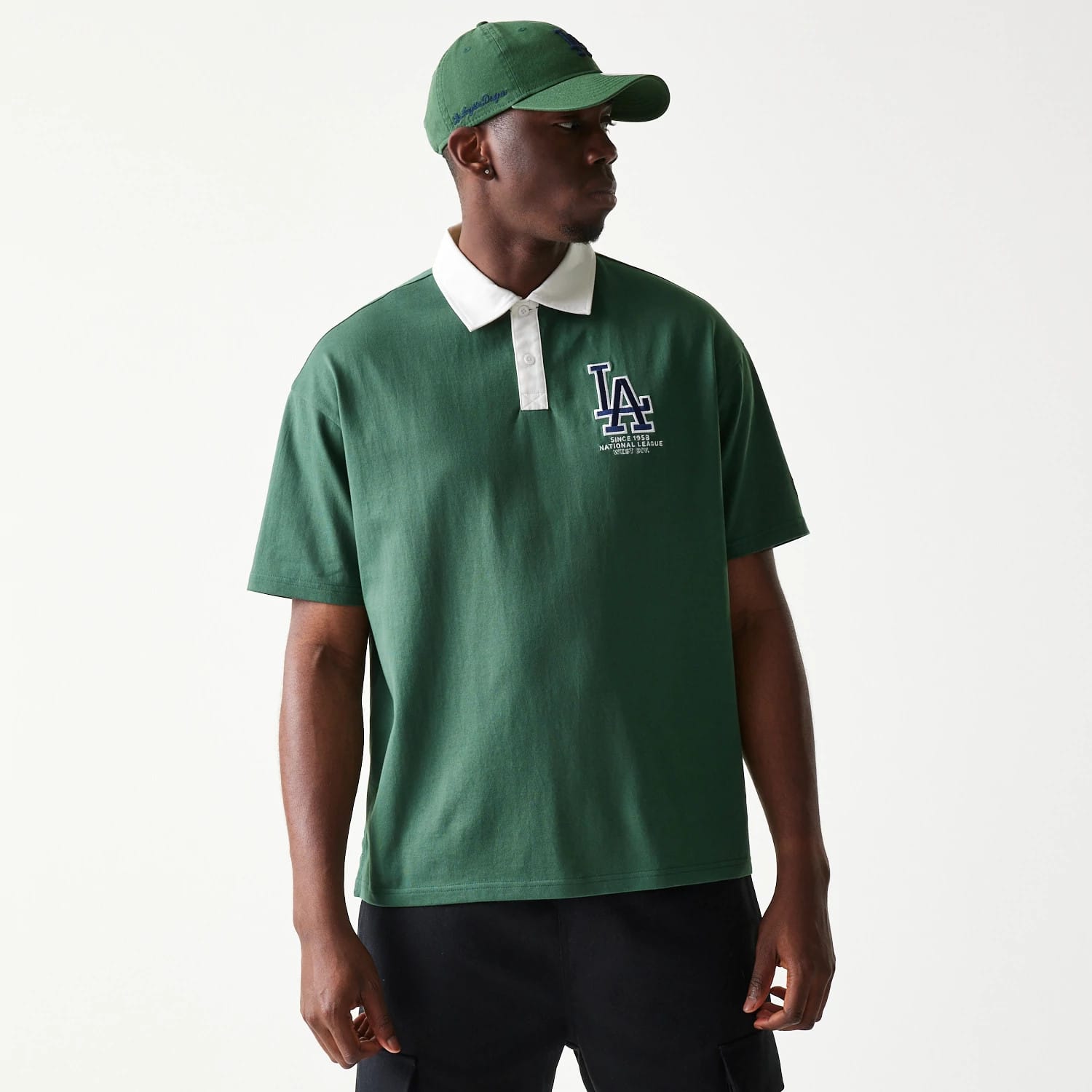 The model is wearing this MLB LA Dodgers Oversized Polo T-Shirt in dark green. 1