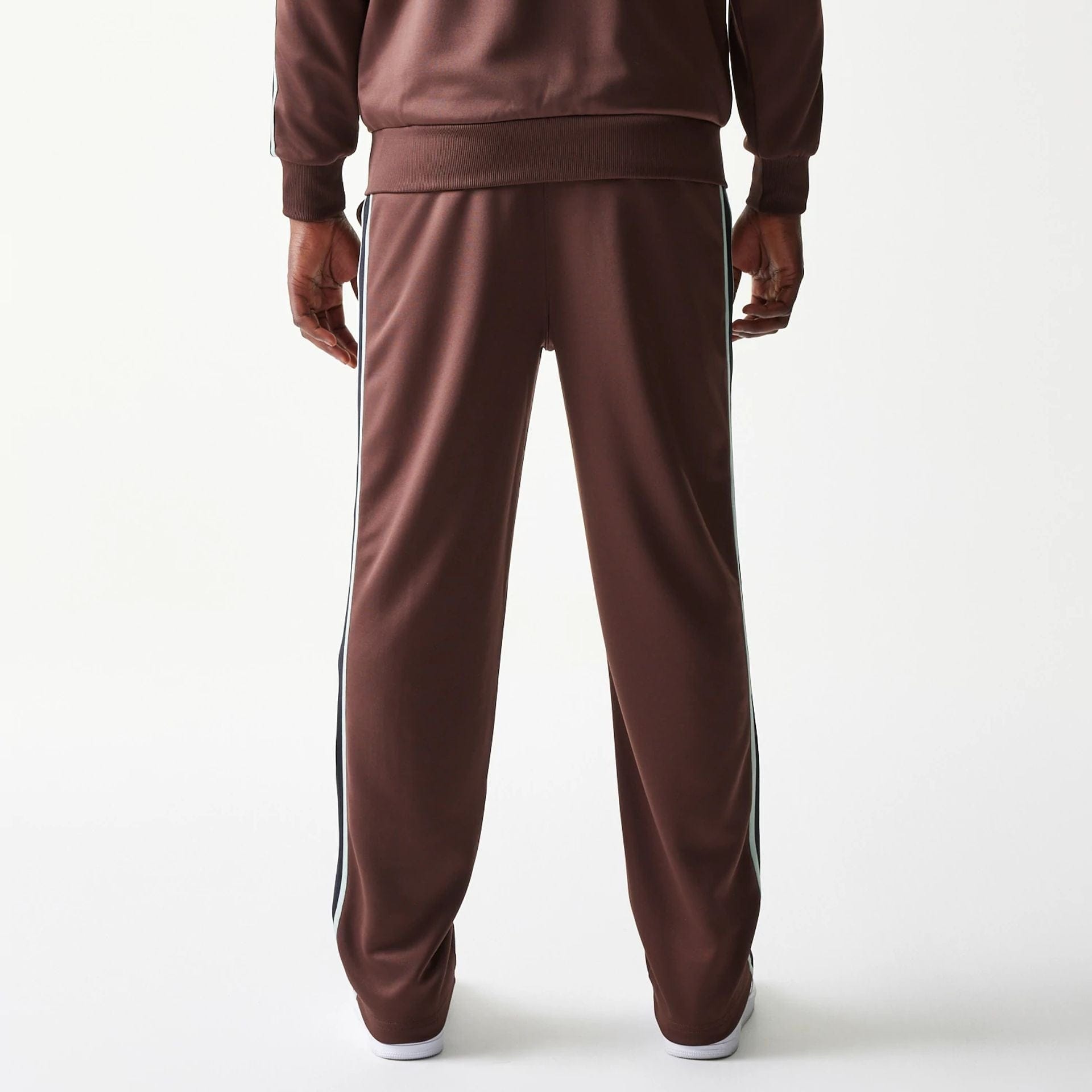 The model is wearing this New Era Script Straight Leg Joggers in brown. 2