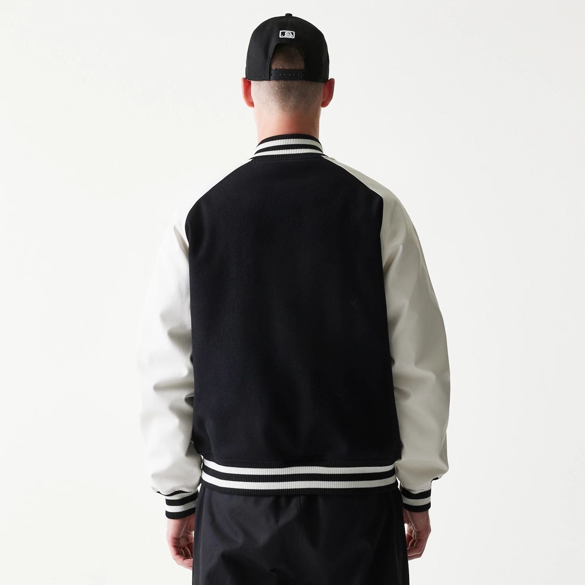 The model is wearing this MLB New York Yankees Varsity Jacket in black. 2