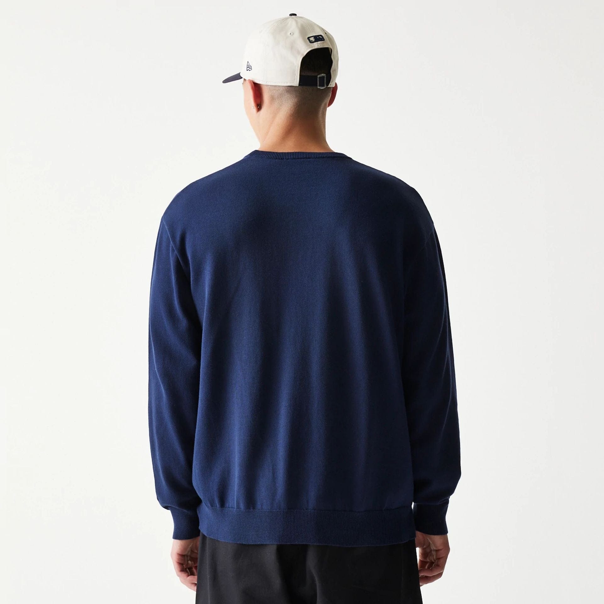 The model is wearing this MLB Essential New York Yankees Knitted Sweater in navy. 2