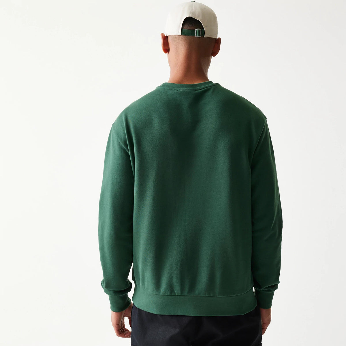 New Era New York Yankees MLB Graphic Dark Green Oversized Crew Neck Sweater, back view on a model showing the relaxed fit and ribbed at the hem and cuffs, with plain dark green fabric for a clean and simple design.