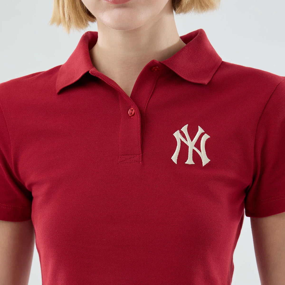 New Era New York Yankees Womens MLB Dark Red Cropped Slim Polo T-shirt, front view showing a classic polo design with a collar and button placket, featuring an embroidered white New York Yankees logo on the left chest.