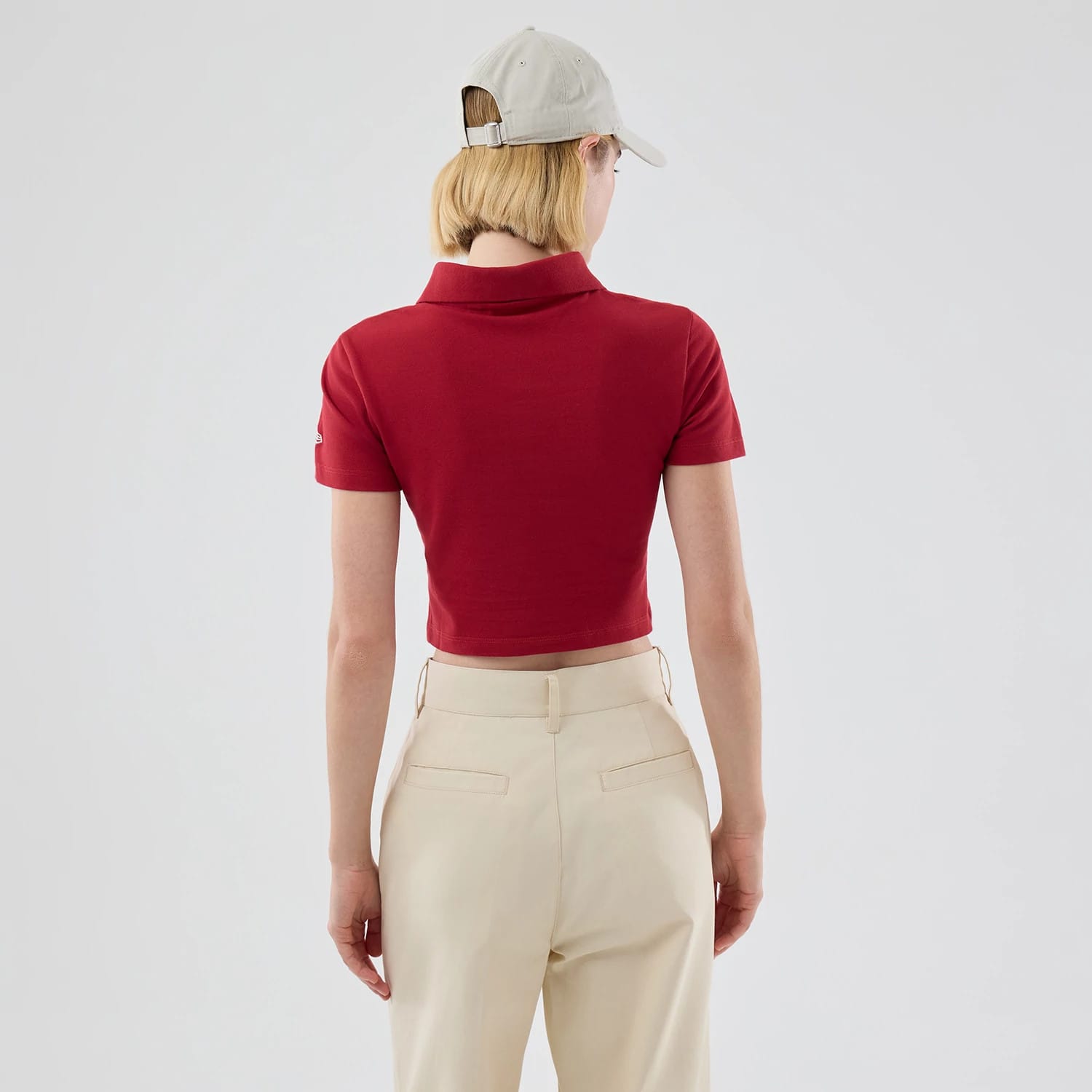 New Era New York Yankees Womens MLB Dark Red Cropped Slim Polo T-shirt, back view on-model showing the cropped hemline and short sleeves with an embroidered Yankees logo on the left arm.